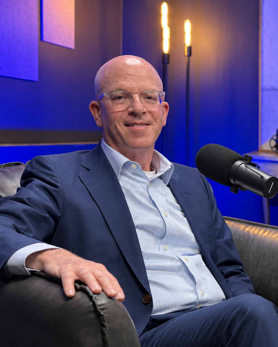 Lee Scheinbart, MD, smiling beside a microphone in the podcast studio.
