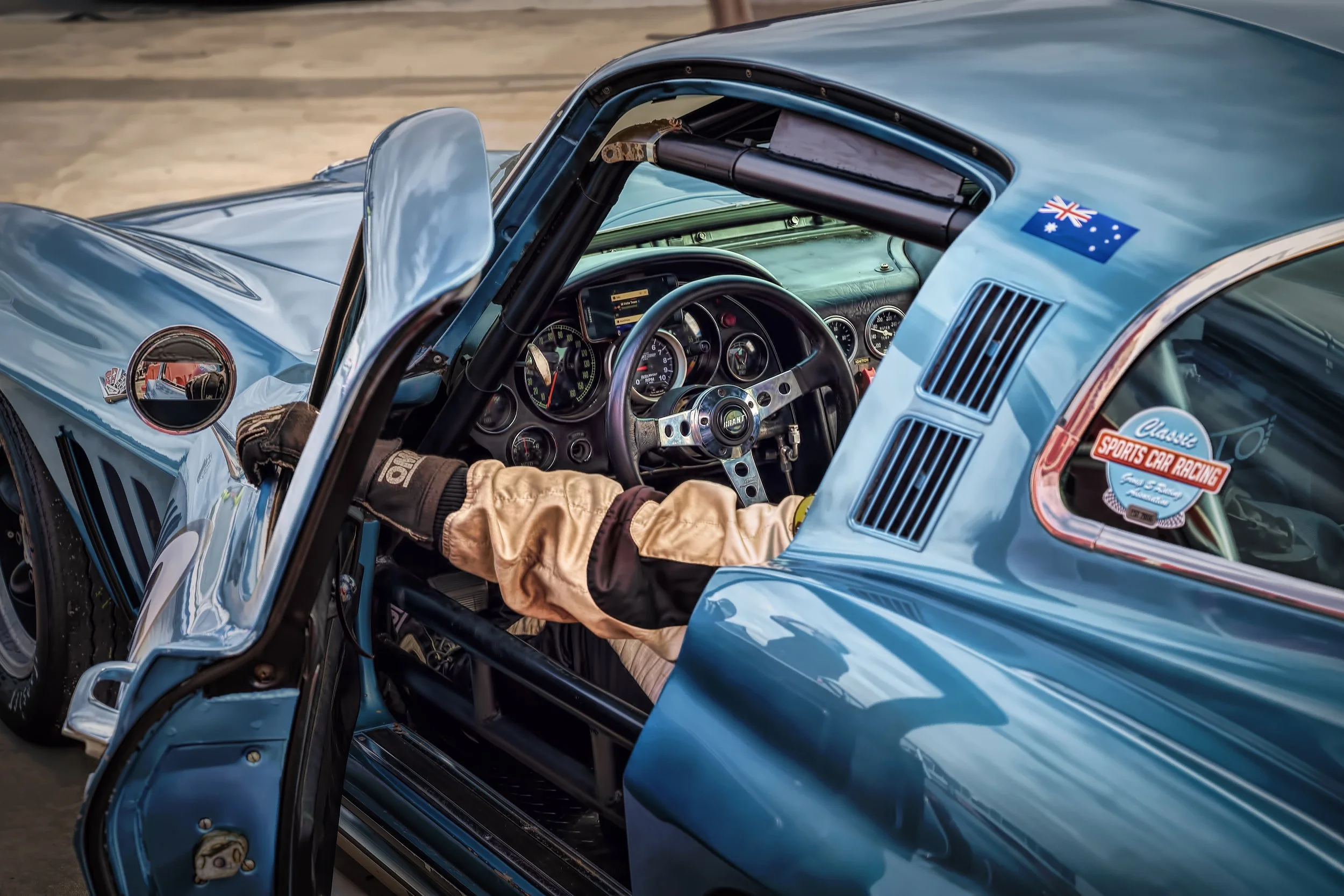 Close-up of a Corvette racing car interior with a driver waiting before the race starts.