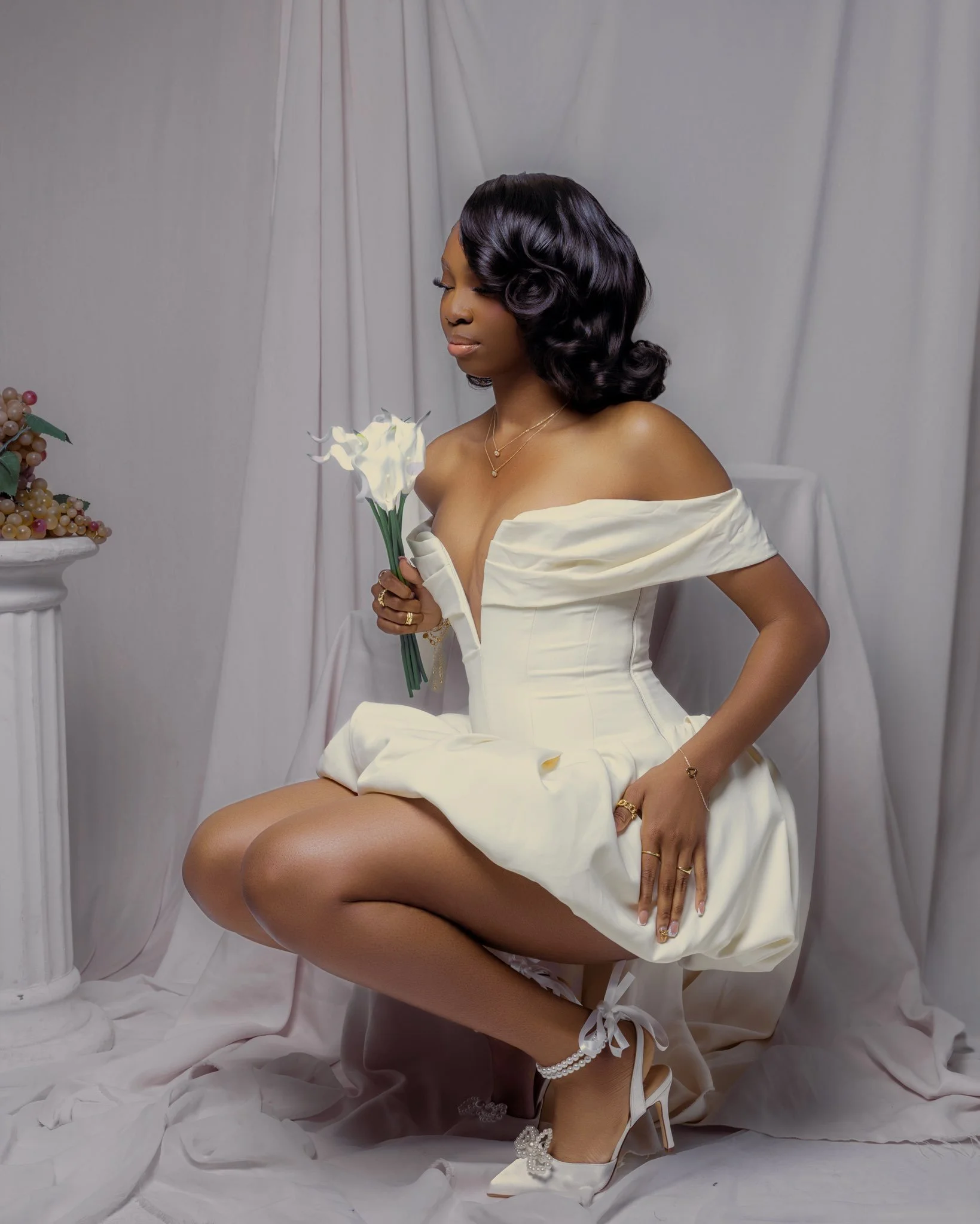 Laurie’s customers, Mariana and Carmen holding hands on a green lawn on their wedding day.