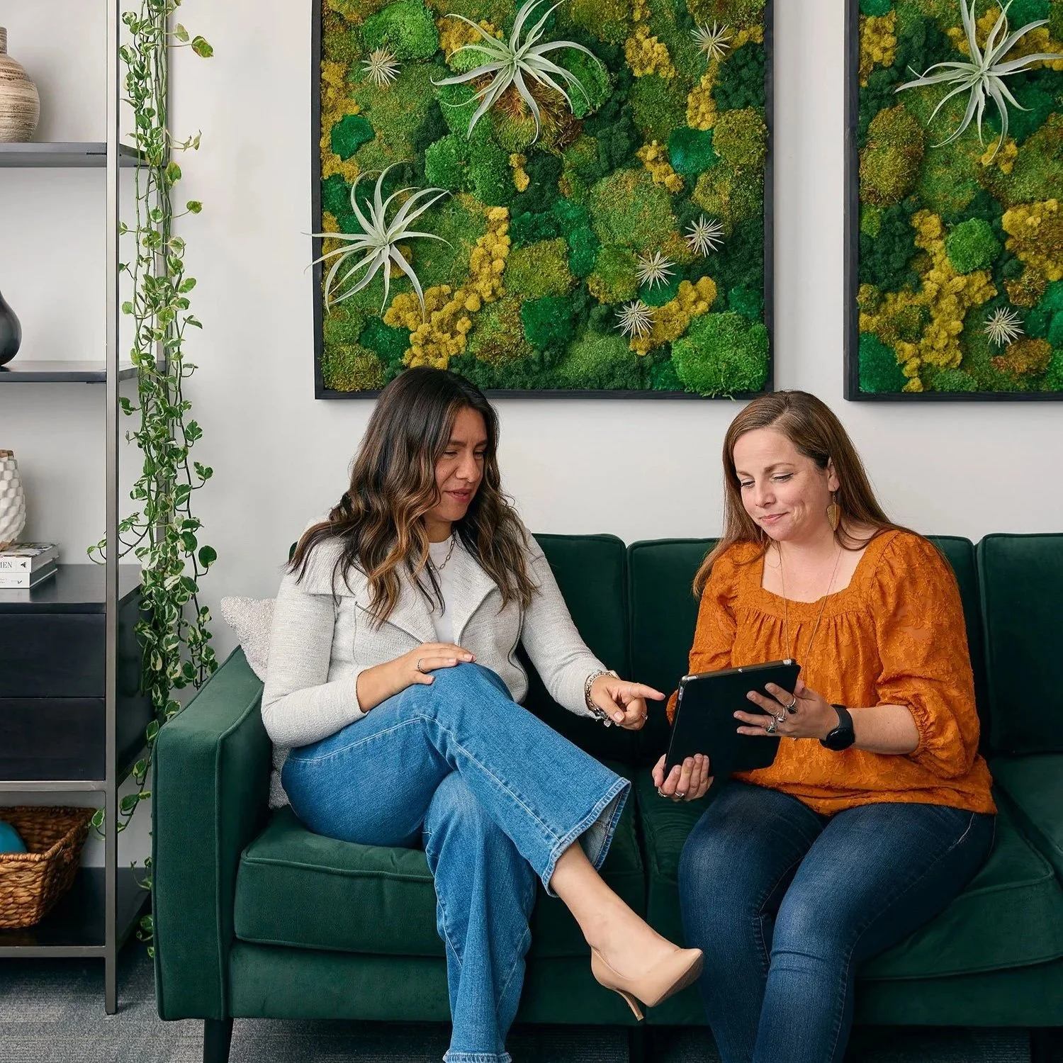 Moss Nonprofit Accounting team members discussing documents in a casual, client-friendly office space.