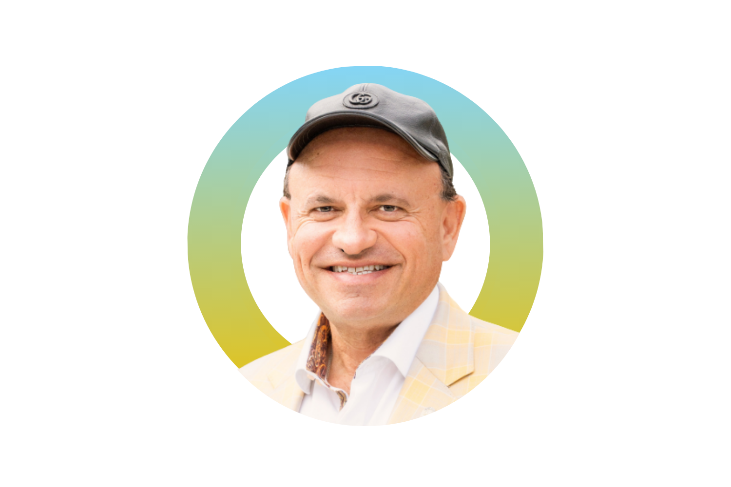 A smiling middle-aged man wearing a black cap and a light yellow blazer over a white collared shirt, with a colorful background.