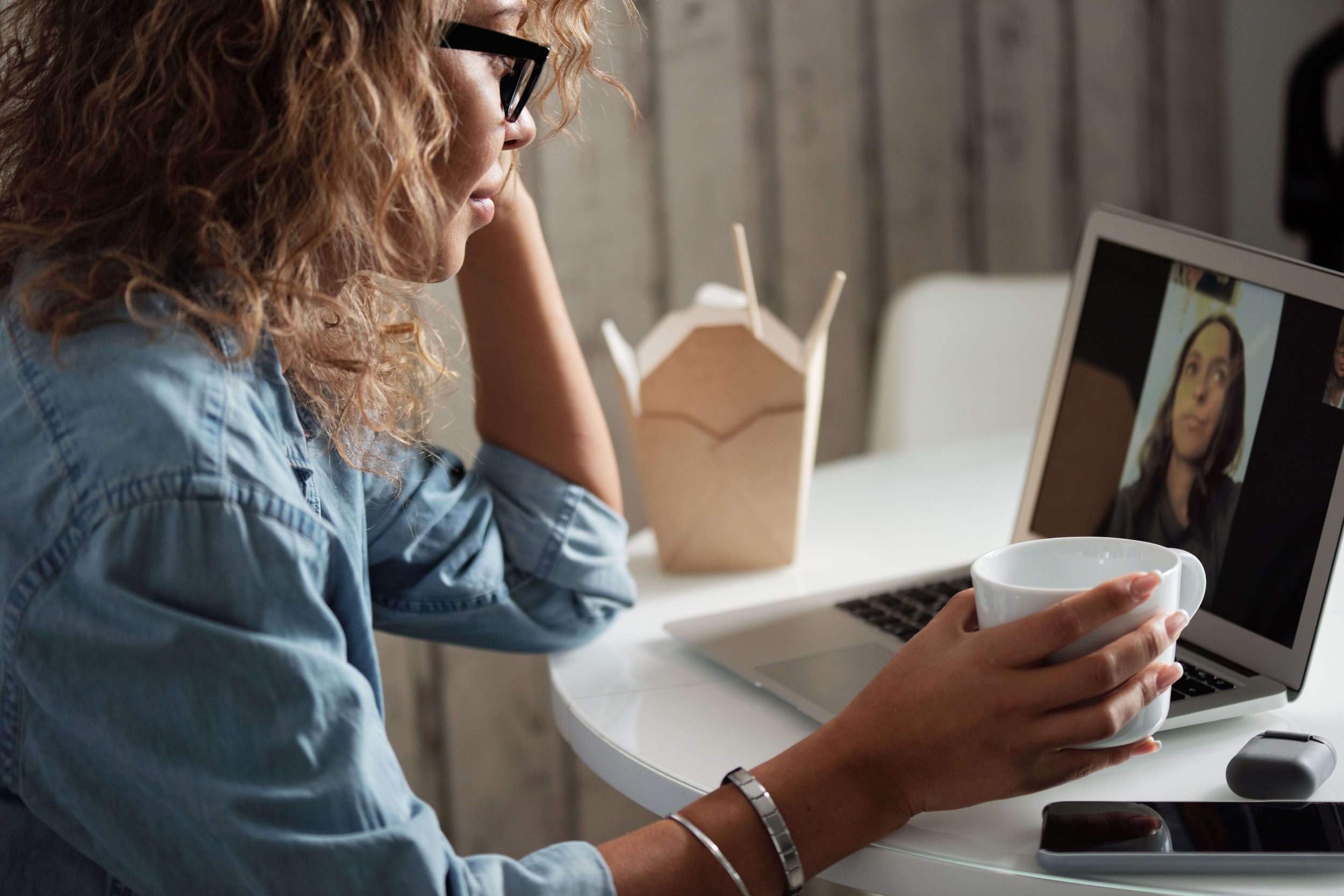 Woman looking at laptop for virtual therapy session