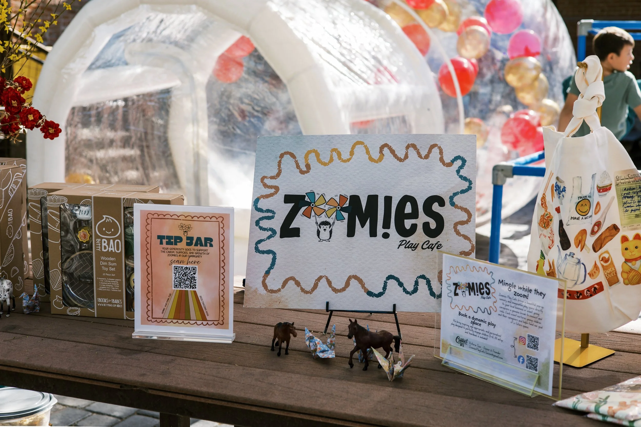 Exterior of Zoomies Play Cafe featuring playful signage, family-friendly atmosphere, and kids party venue setup.