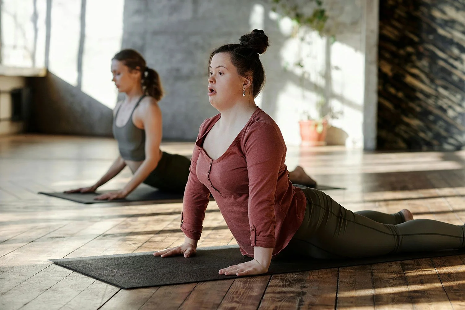 Woman with down syndrome taking a yoga class