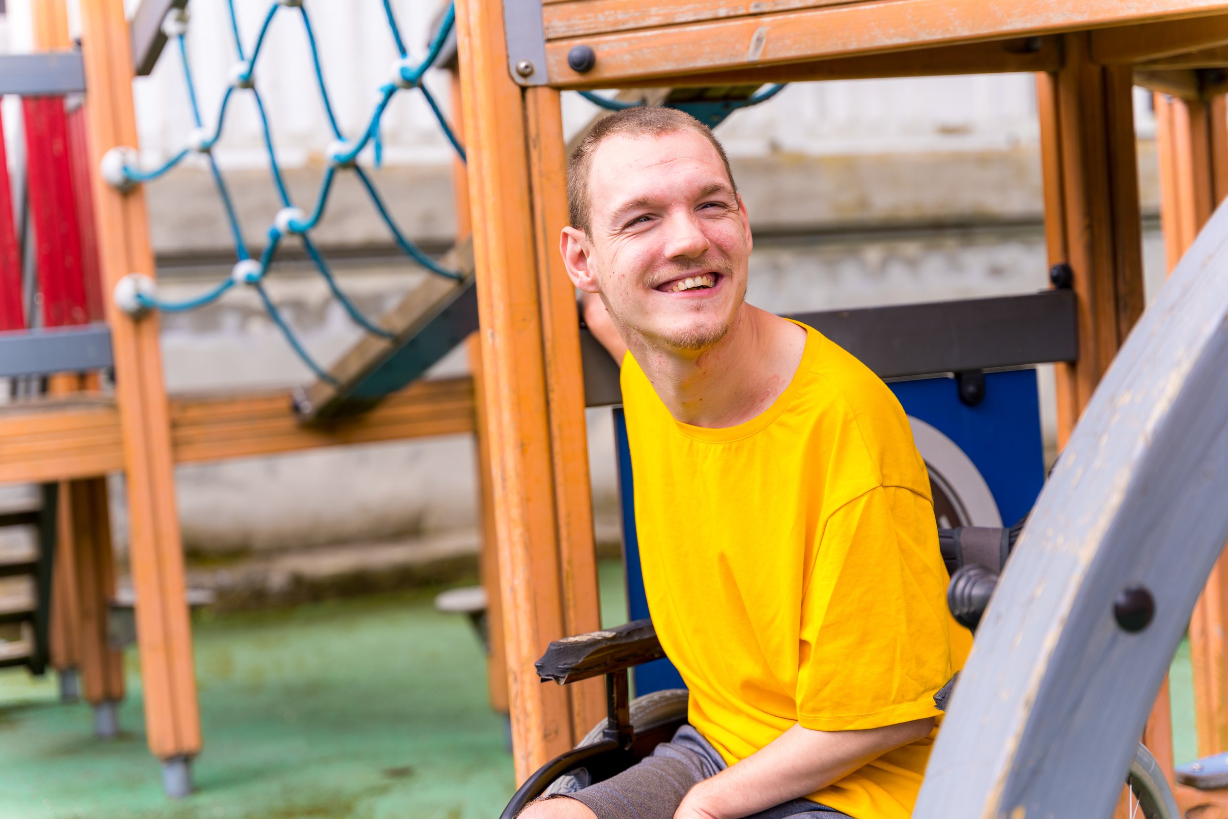Disabled man smiling on the playground