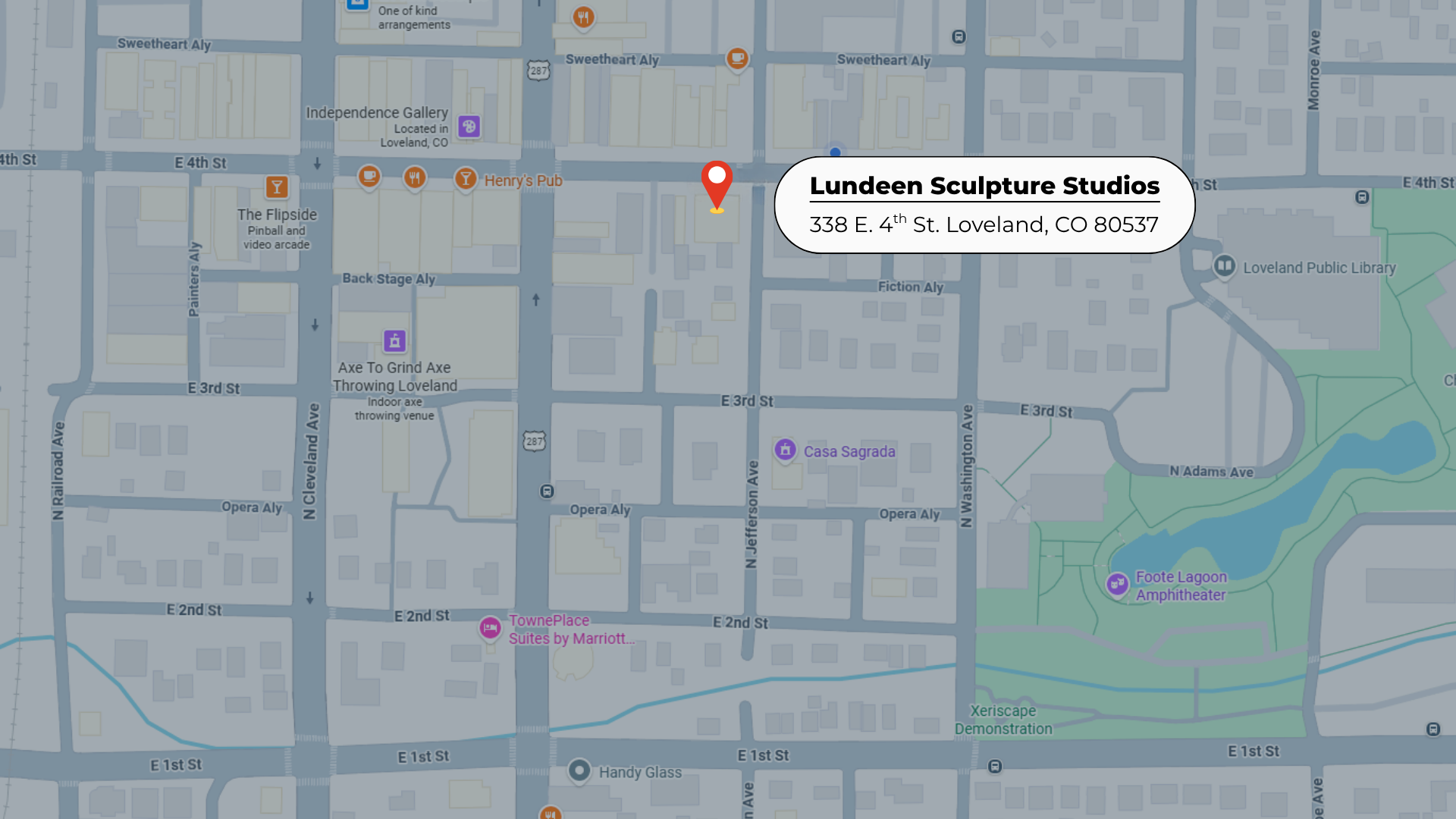 Map showing the location of Lundeen Sculpture Studios at 338 E. 4th St. Loveland, Colorado, with nearby streets, landmarks, and businesses like the Loveland Public Library and Foote Lagoon Amphitheater.