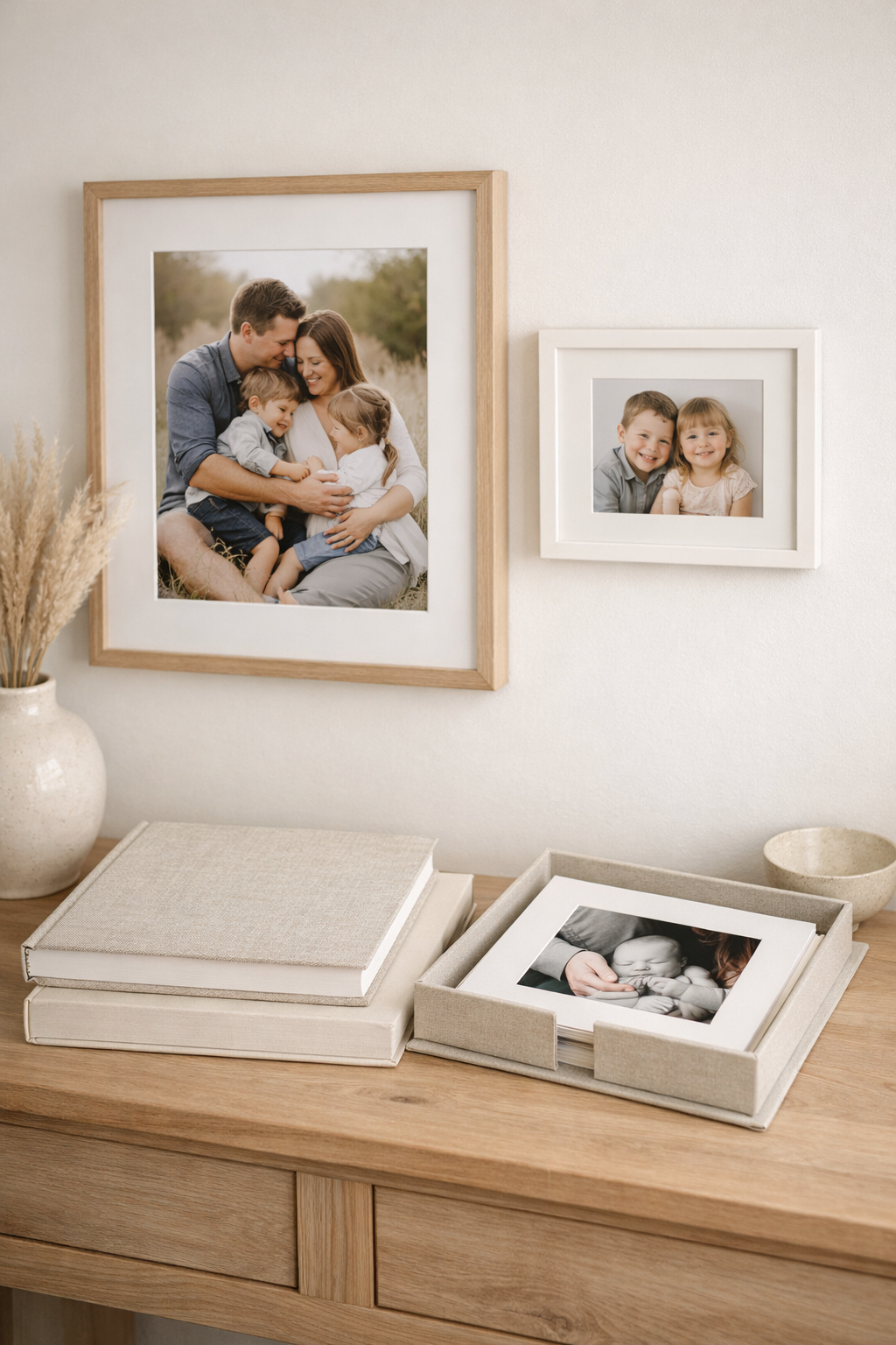 Framed family photographs and an album displayed in a home