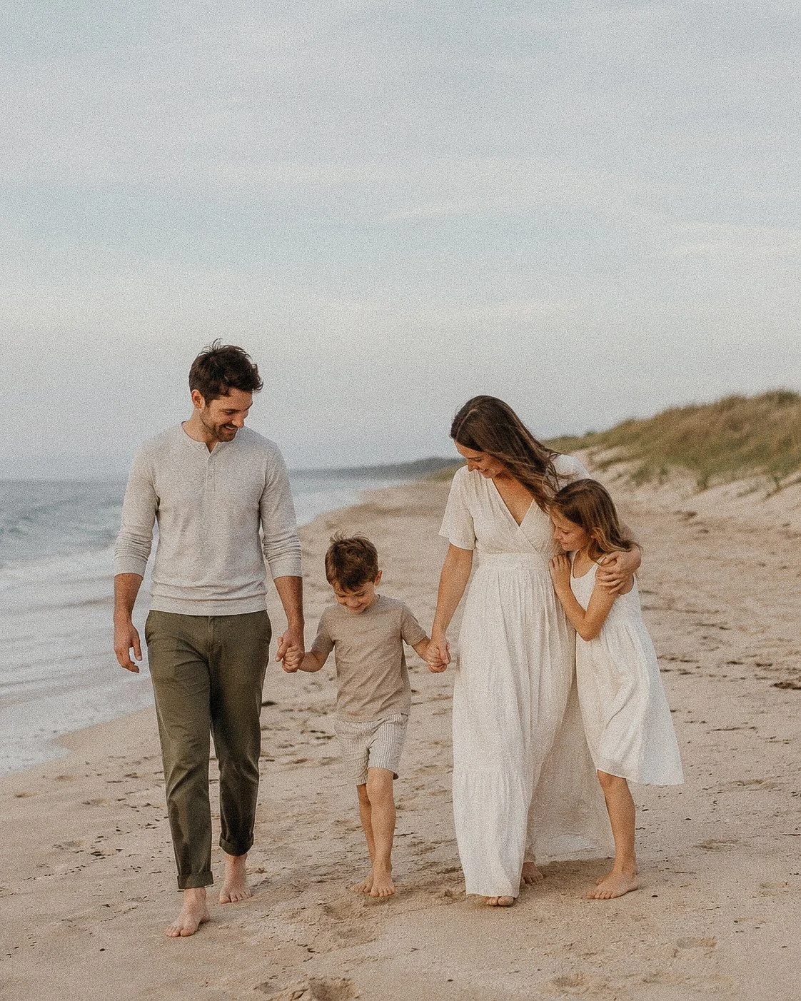  Family walking together along the shoreline 