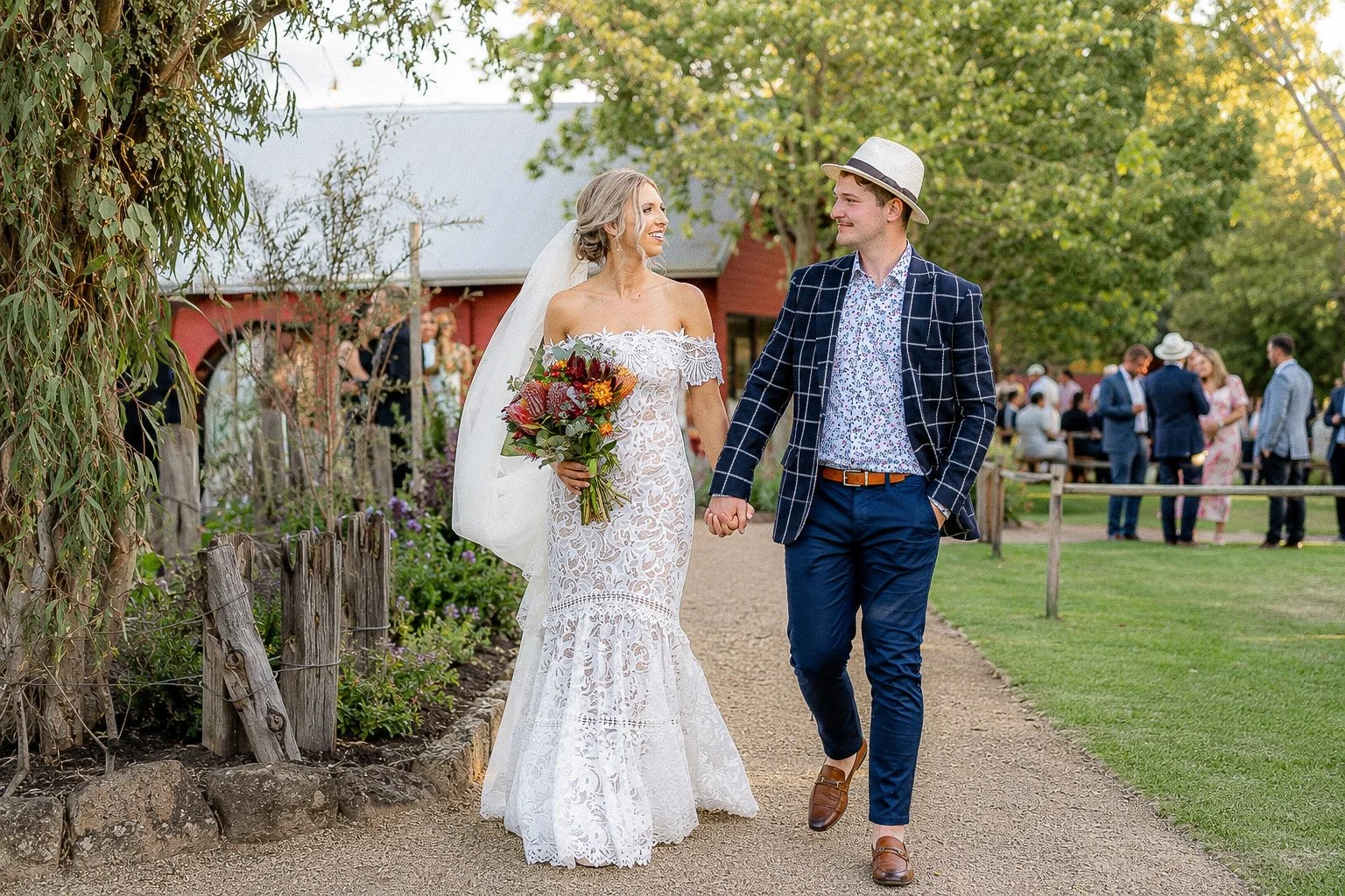 Bride and groom walking together through their wedding venue.