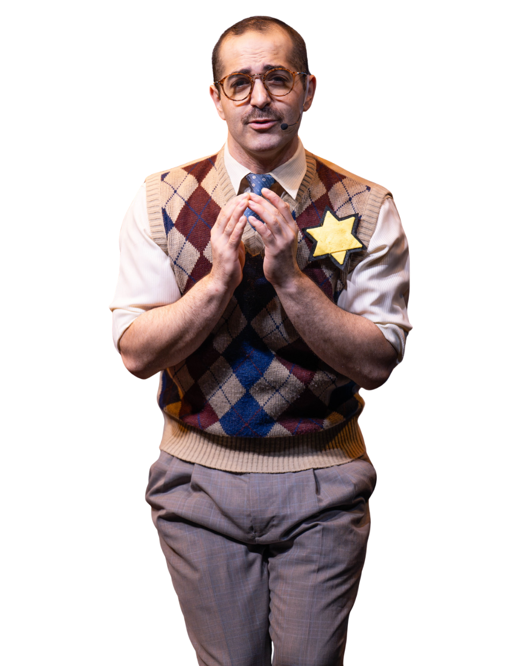 A man dressed as a nerdy police officer or detective, wearing glasses, a microphone headset, a plaid argyle sweater vest, and a star-shaped badge, standing with hands clasped.