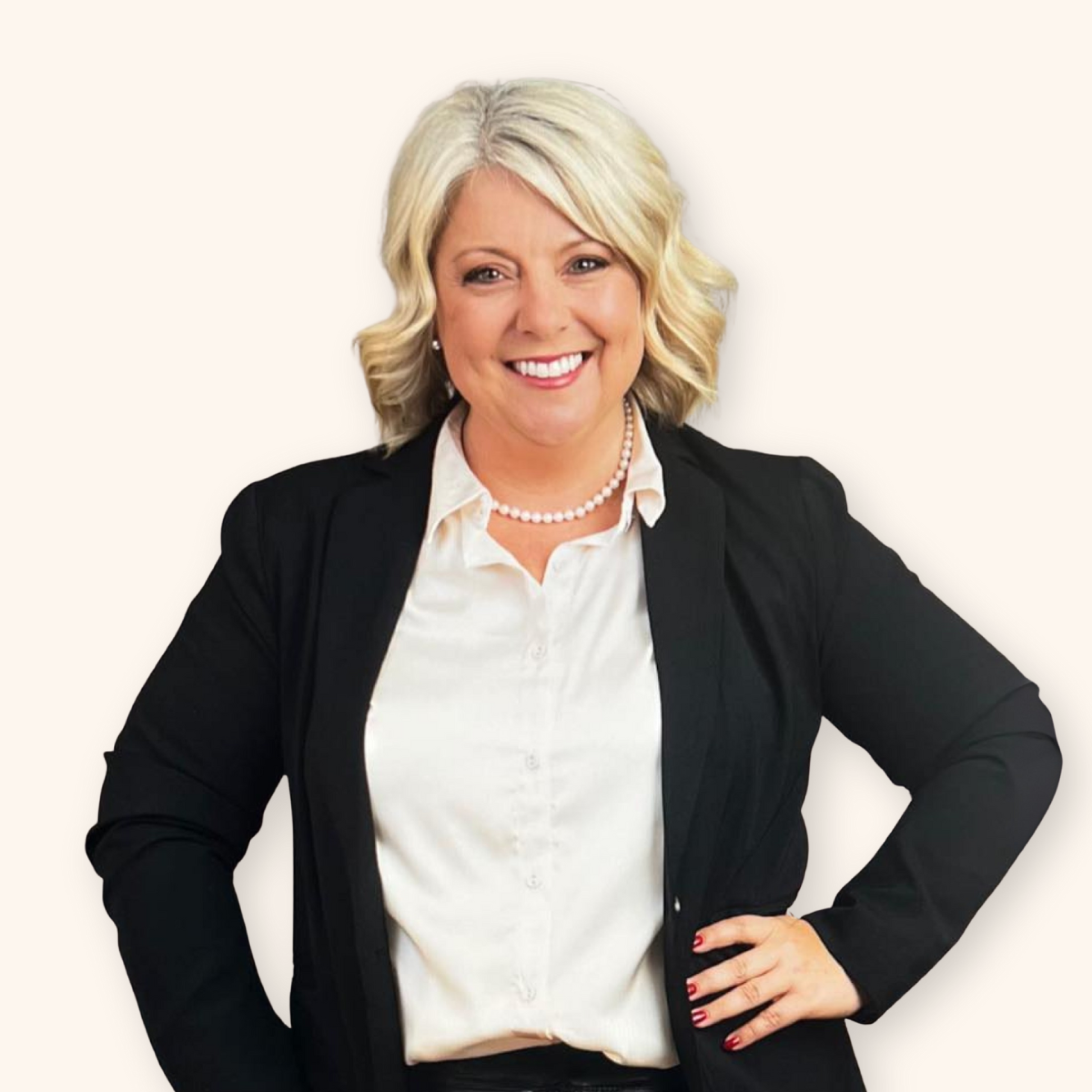 A woman with long, light brown hair smiling, wearing a cream-colored top and a small cross necklace, against a dark blue background.