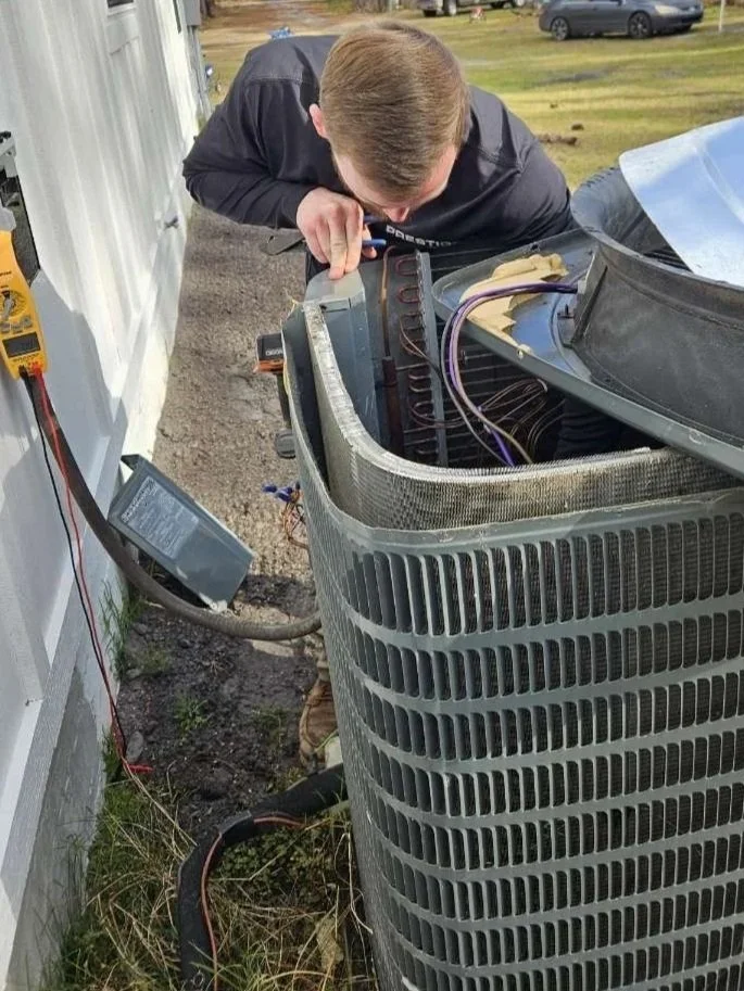 HVAC system with insulated ductwork in a construction interior, with electrical panels and wiring visible.
