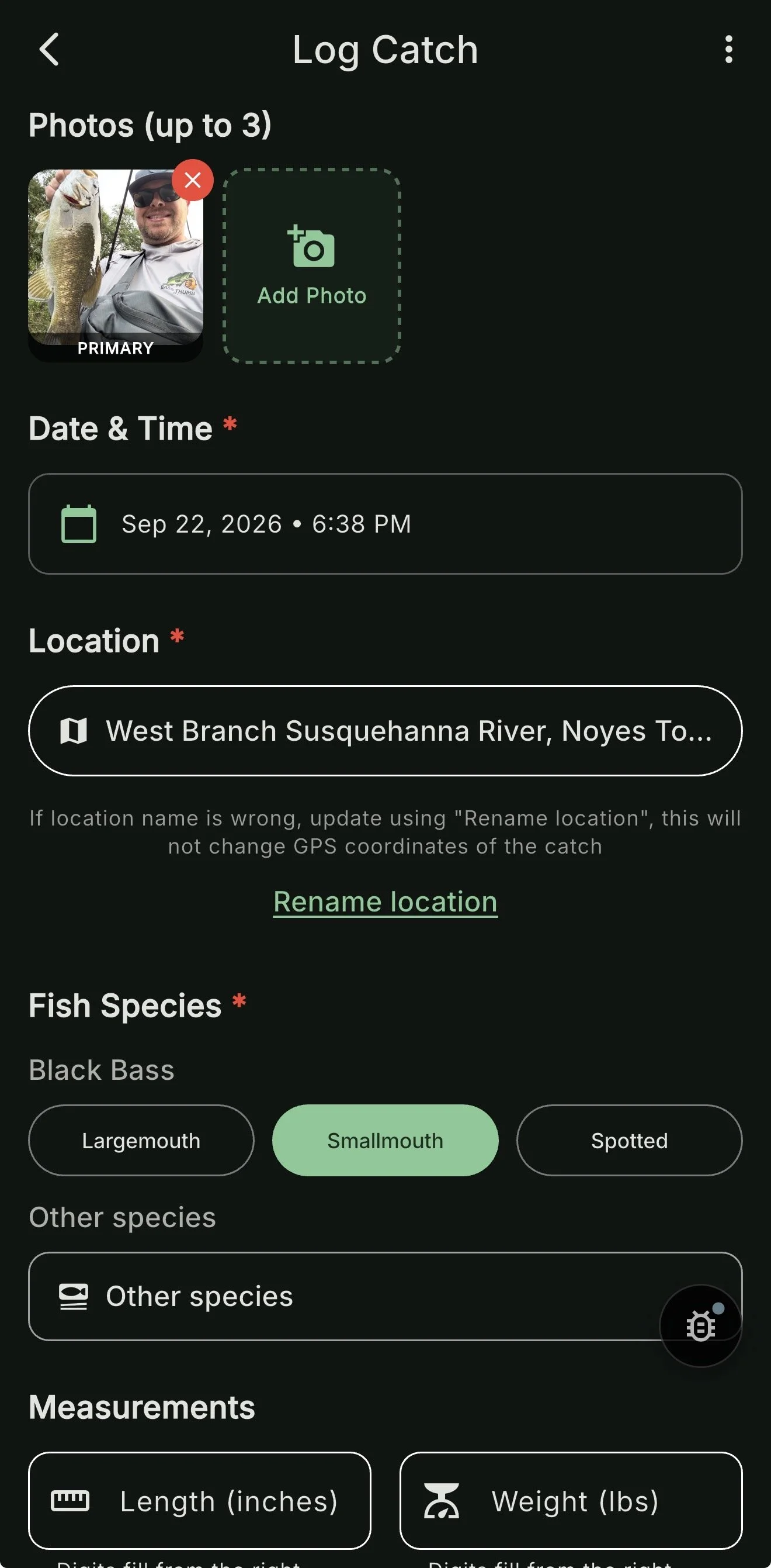 Mobile app screen showing a log catch entry for fishing, with a photo of a man holding a fish, date and time of catch, location at West Branch Susquehanna River, fish species as Black Bass, and size measurements options.