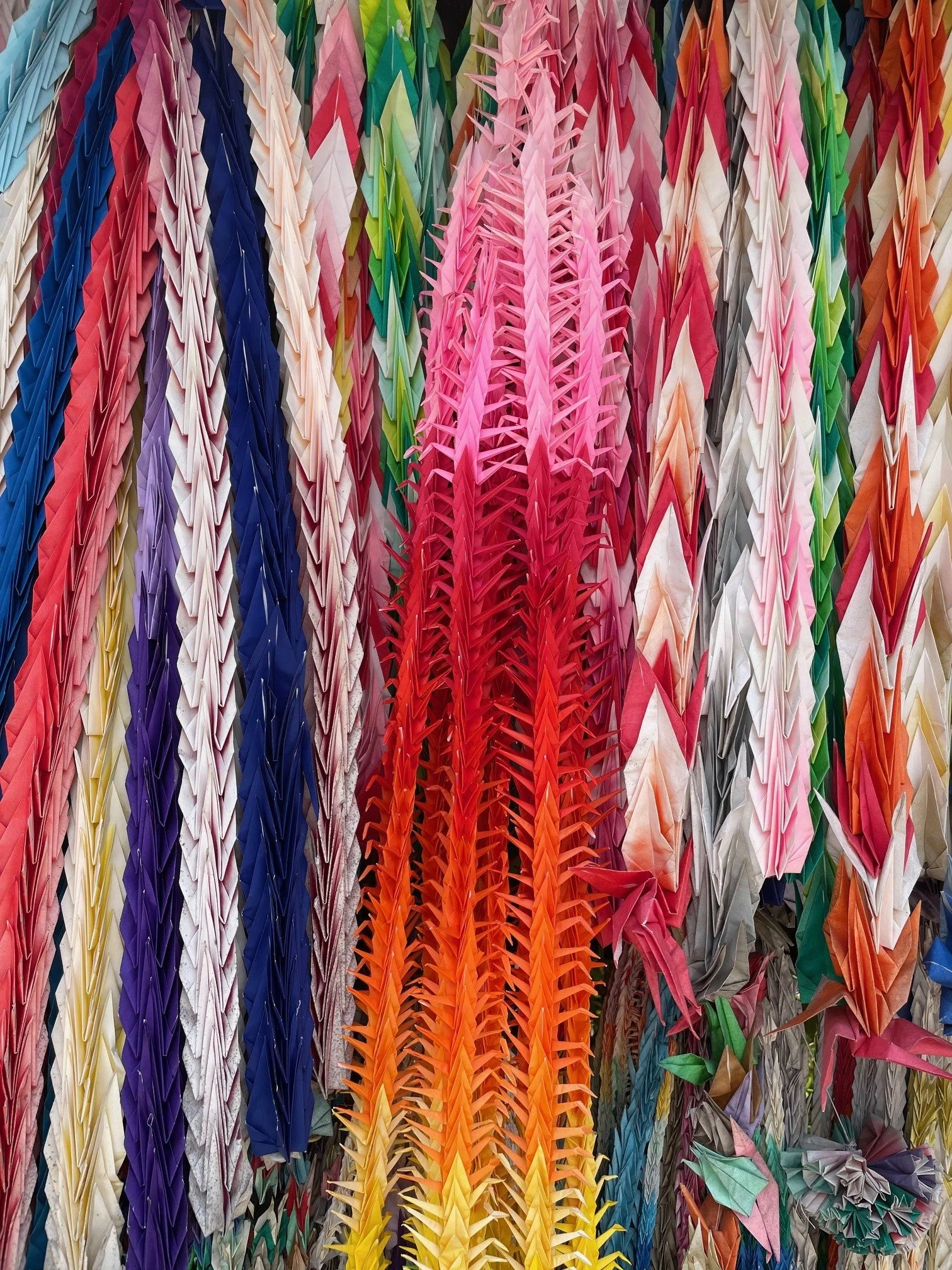 Brazilian charms on a fastener hanging from a metal chain