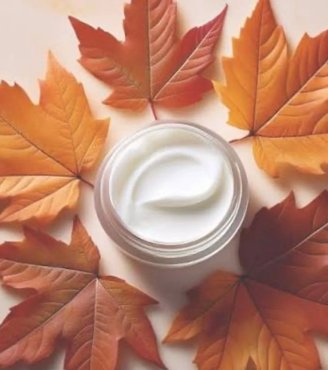 Moisturizer surrounded by autumn maple leaves