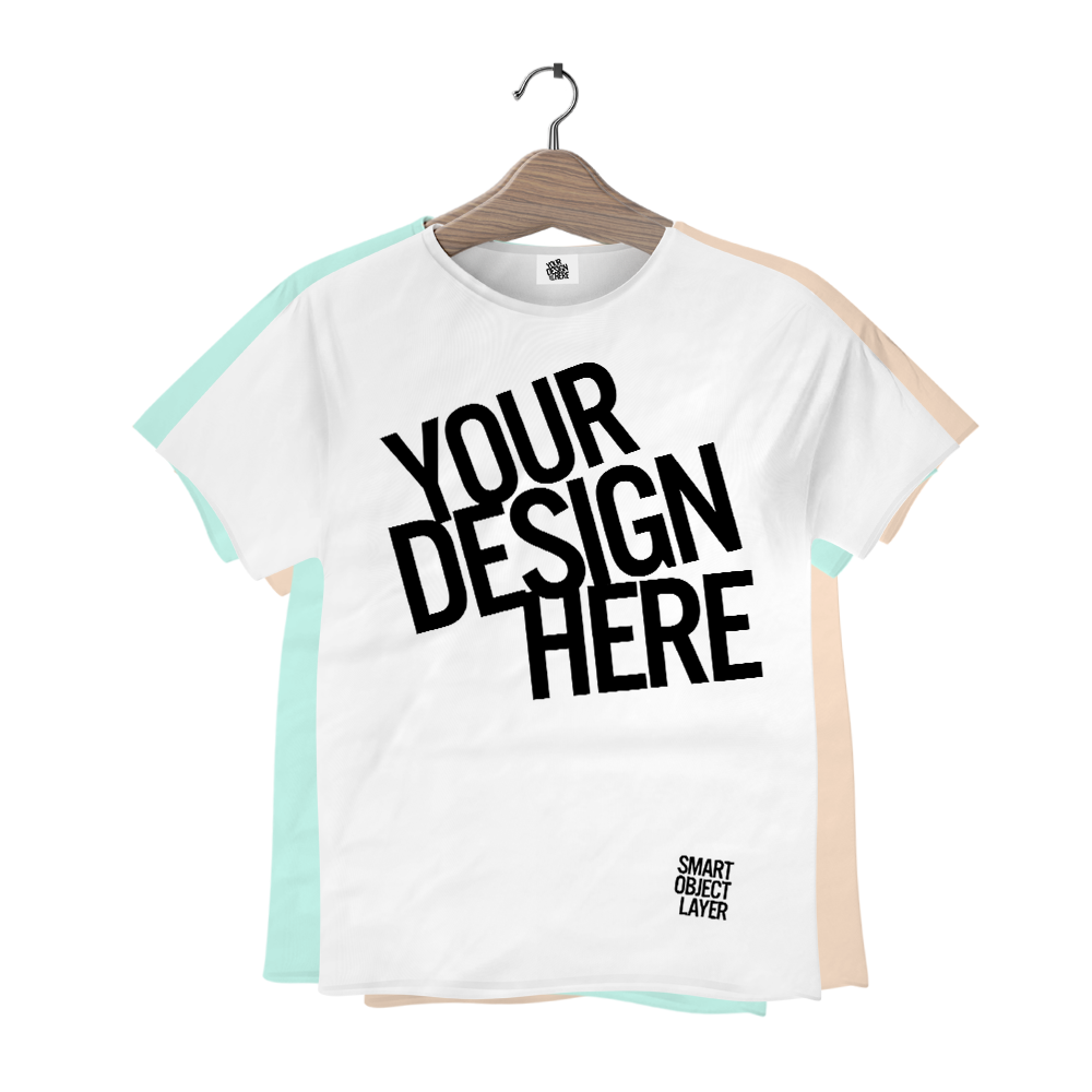 White T-shirt with black text that reads "Your Design Here" and smaller text near the bottom that says "Smart Object Layer", hanging on a wooden hanger against a light-colored background.
