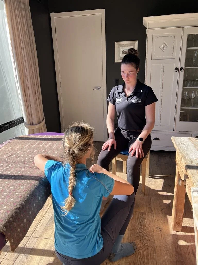 Female horse rider sitting on a chair, undergoing physio treatment for improved performance and recovery