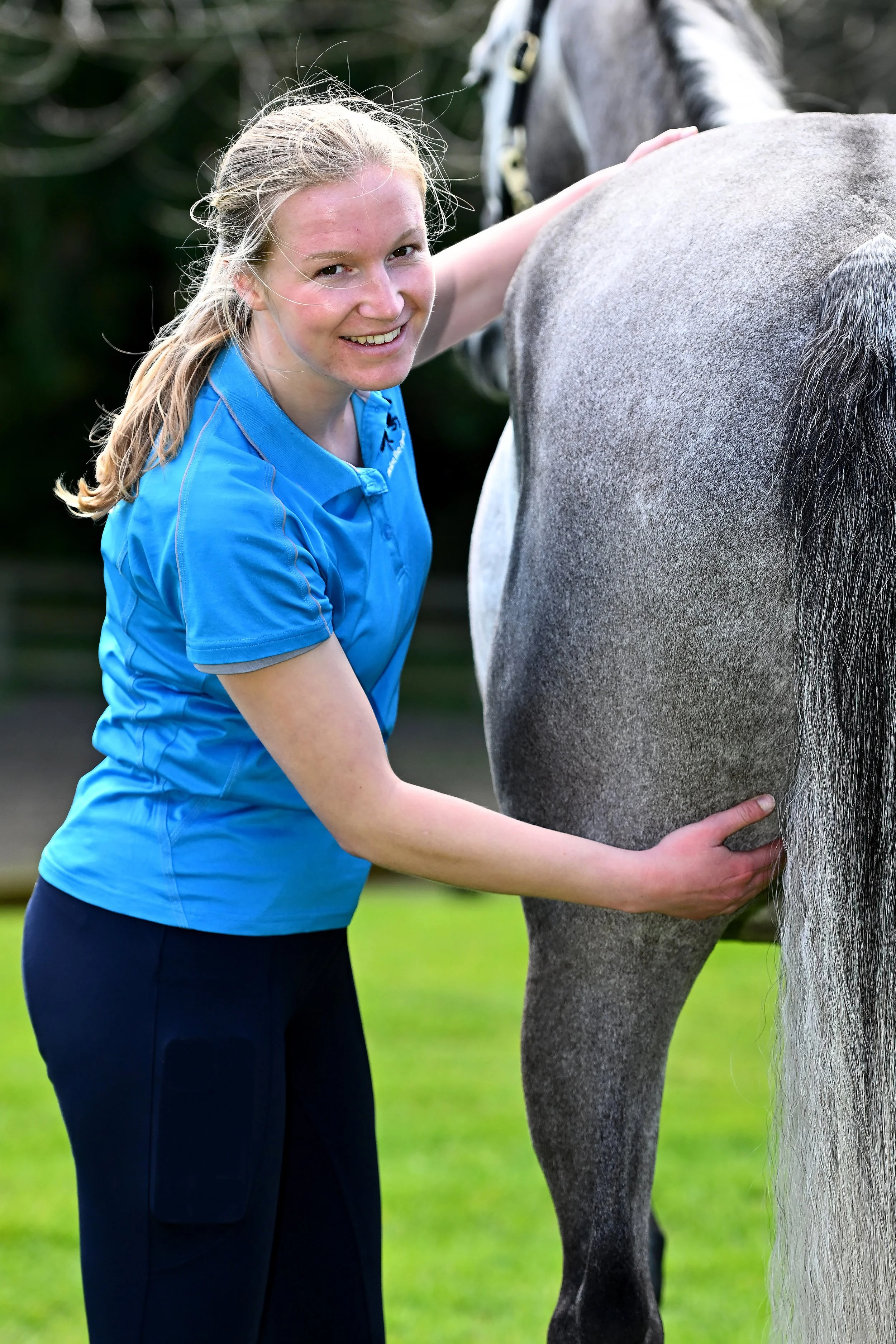Veterinary Physiotherapist Molly Robinson with grey horse