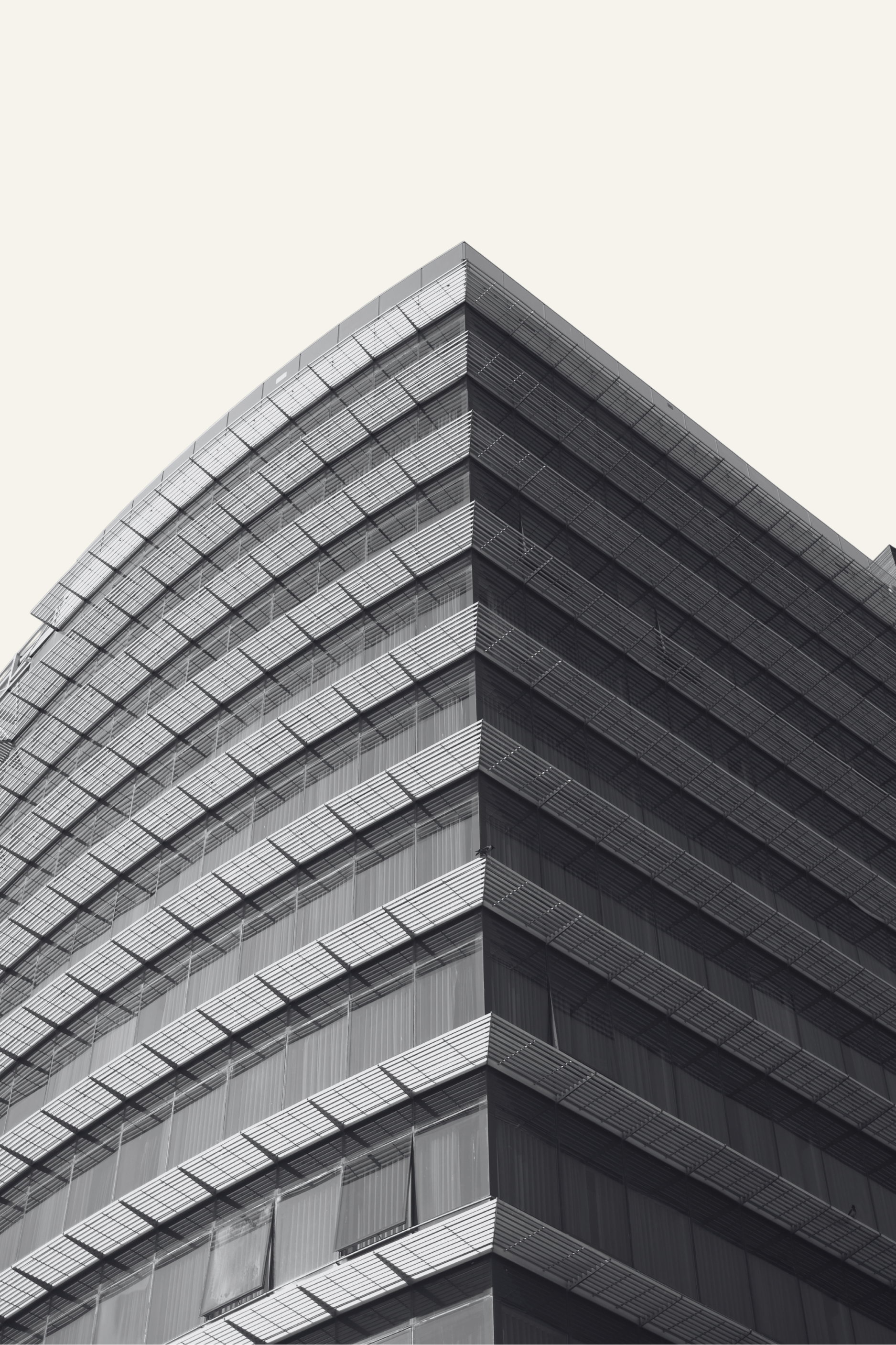 Modern luxury high-rise architecture with geometric lines and layered facade, symbolizing The Lockett Circle’s focus on real estate development and investment.