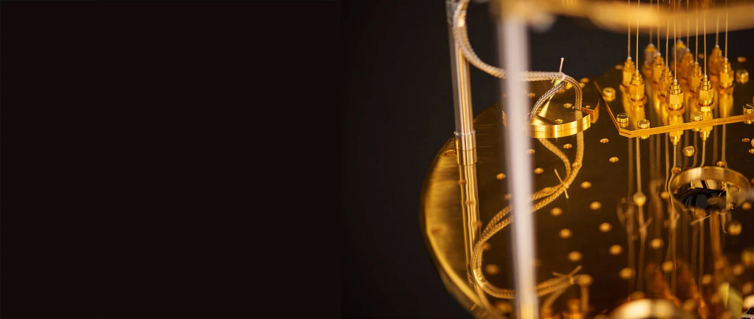 Close-up of a gold-plated mechanical watch movement with intricate gears and components.