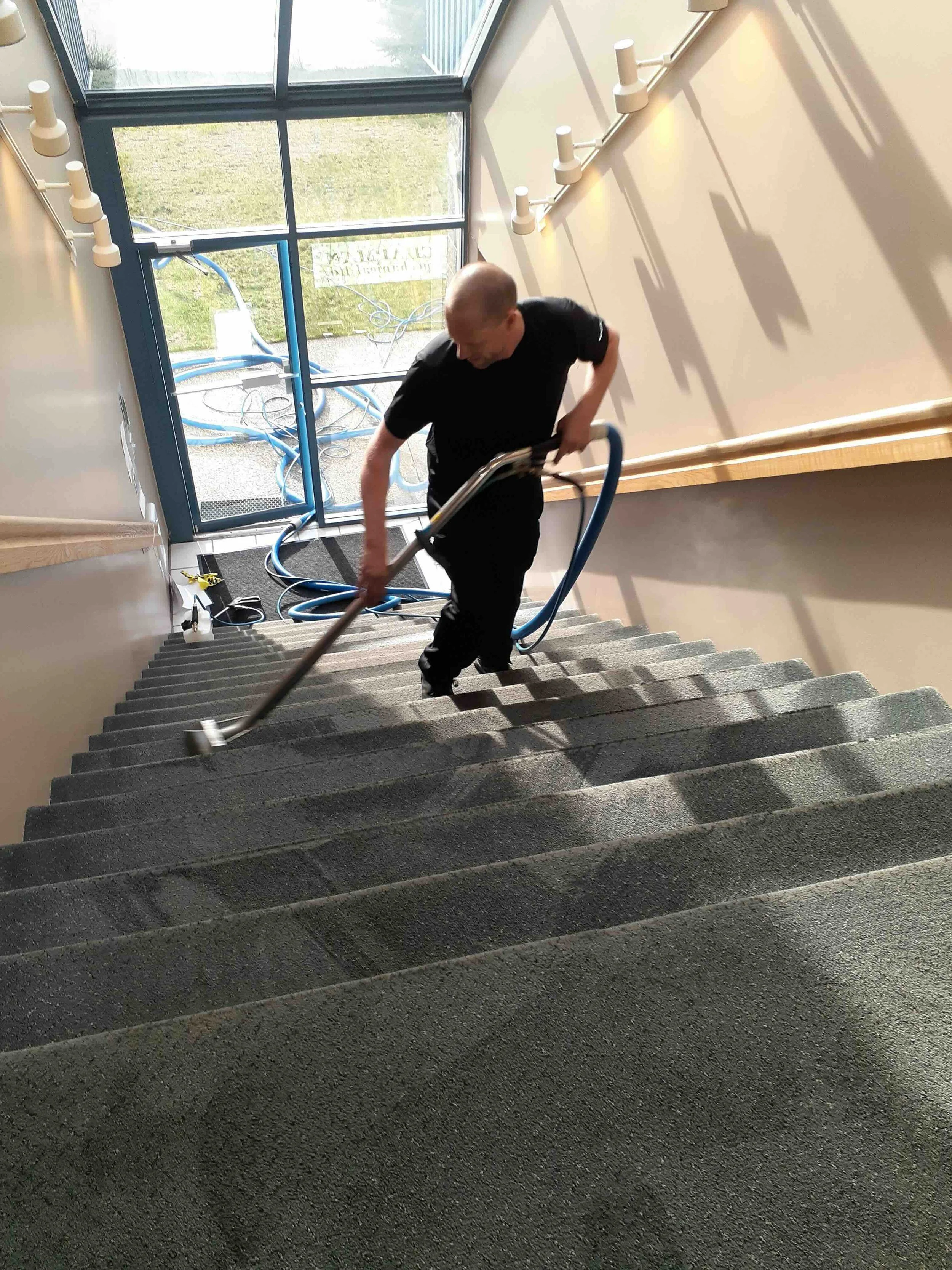 Man carpet cleaning in a staircase of a building in Vernon bc