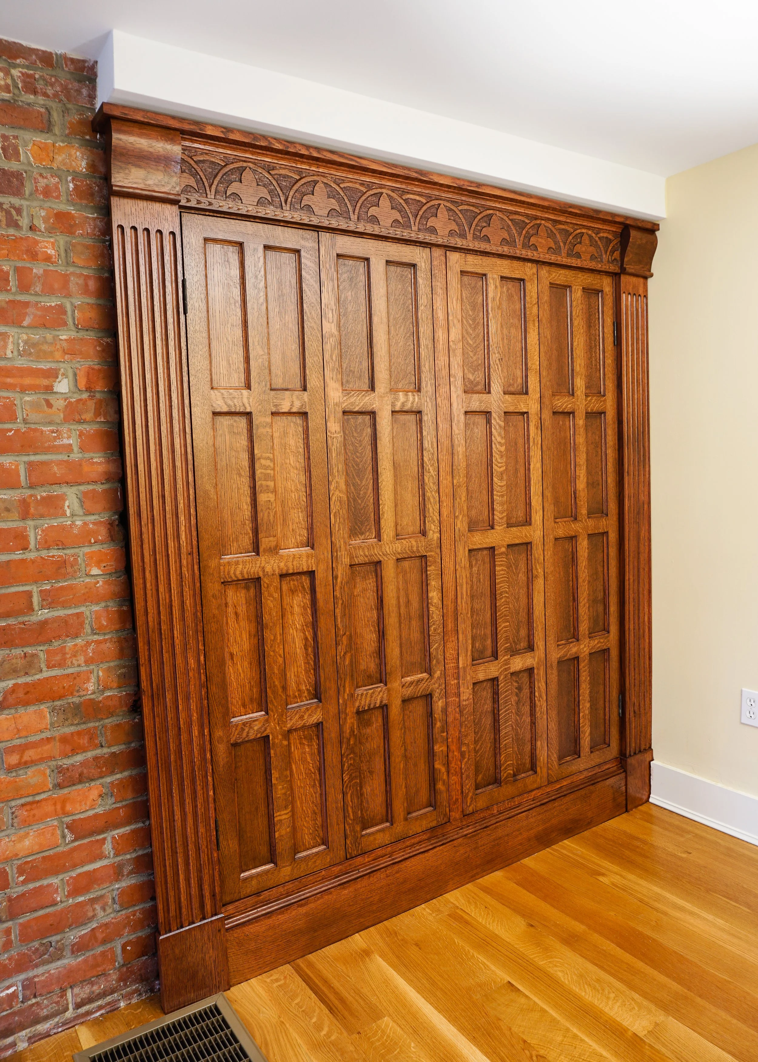 solid white oak built in with bifold doors and custom carvings in the trim