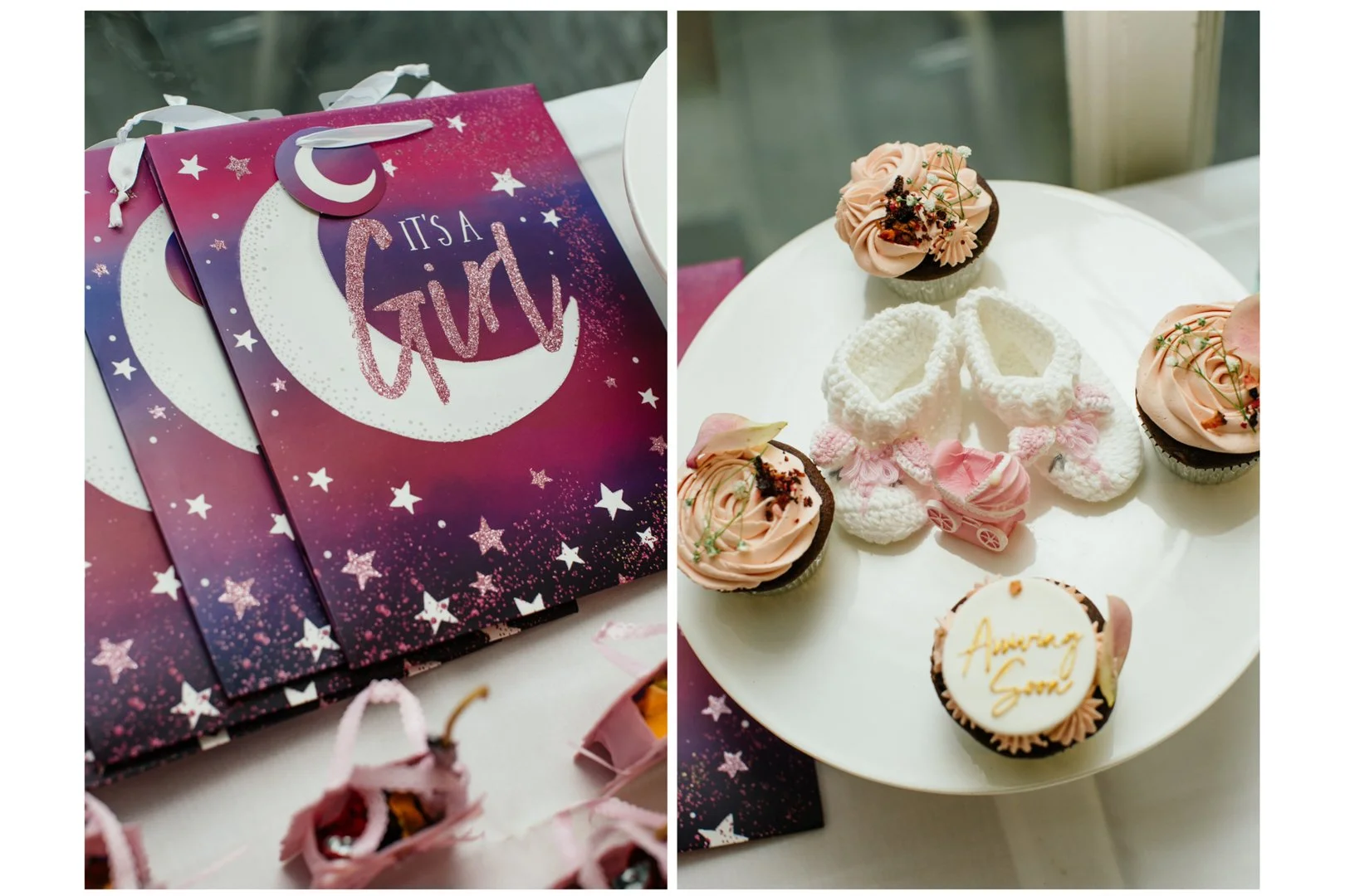 Party decoration with a purple and pink galaxy themed bag with the words 'It's a Girl' and a crescent moon and stars on it, and a white plate with cupcakes, socks, a doll stroller, and a cookie that says 'Amazing Son'.