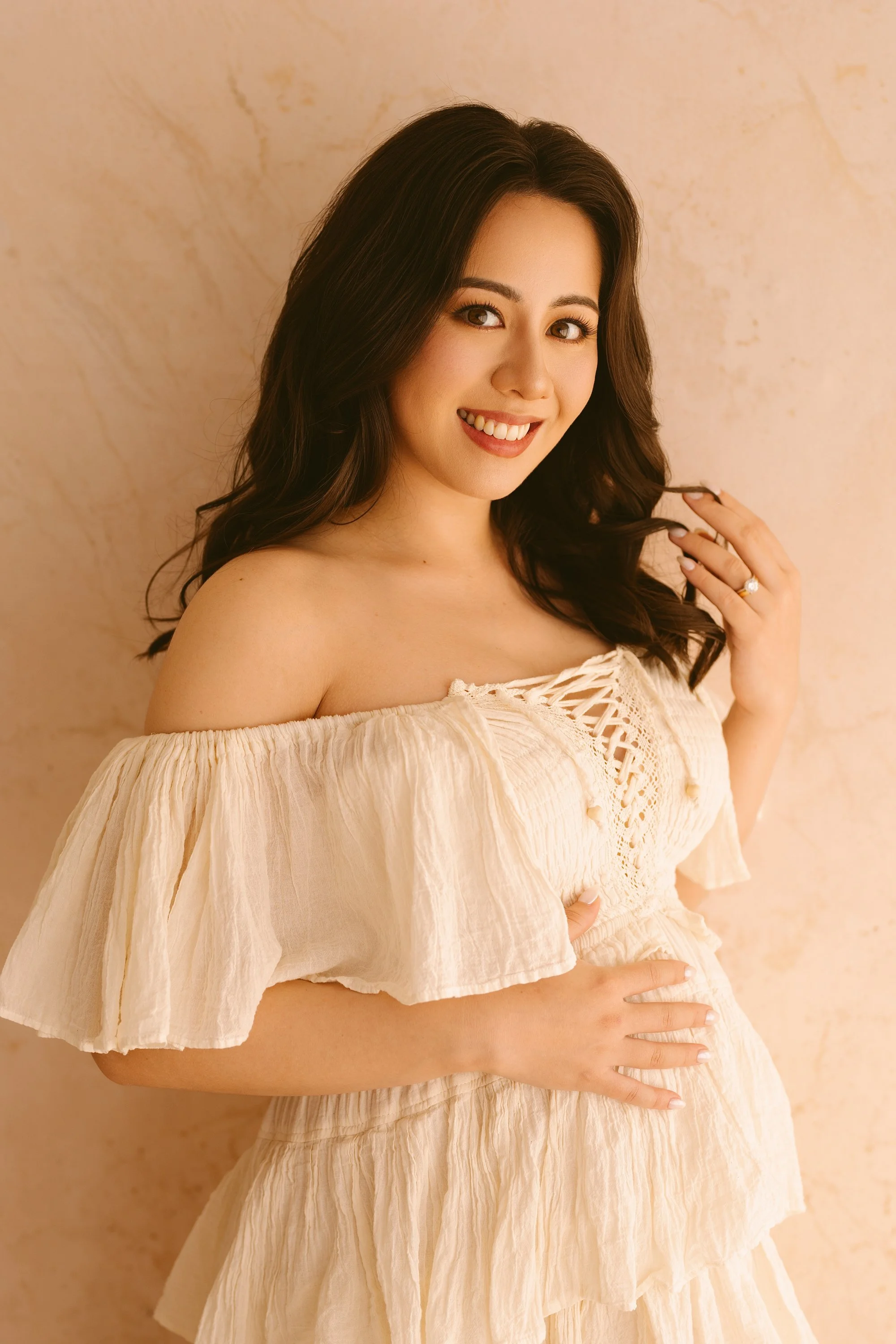 Pregnant mum in a beige maternity gown at Anna Claire Studio Sydney