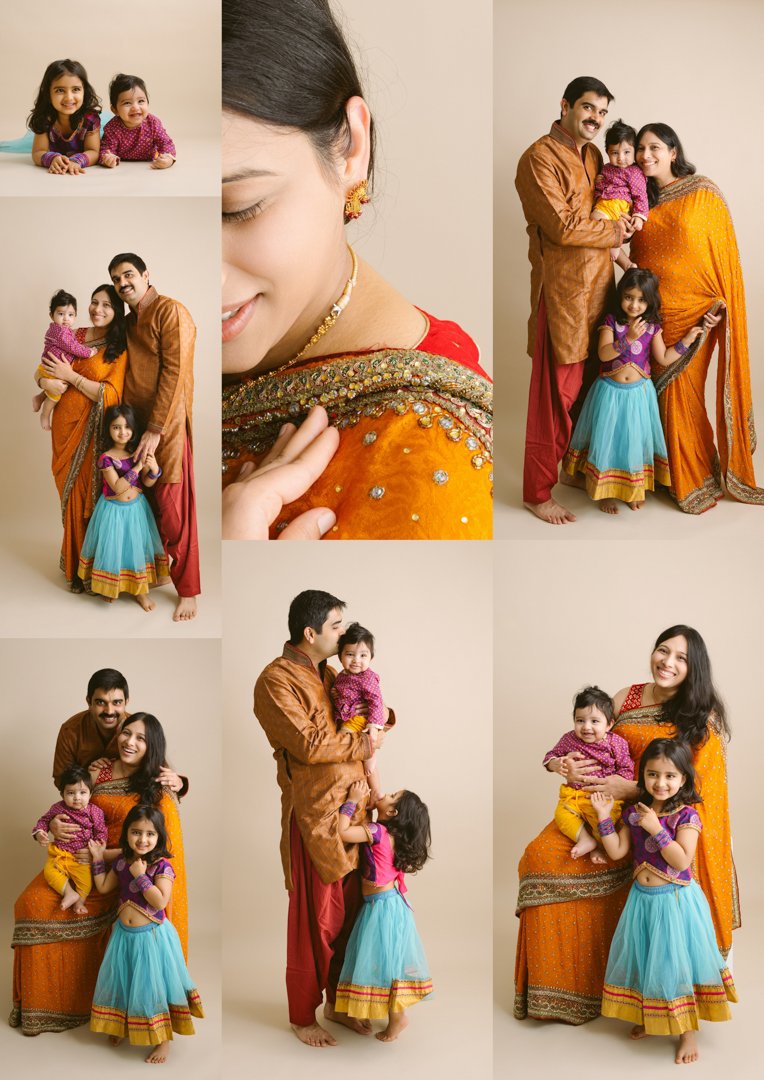 Family photo of a man, woman, and two little girls in traditional Indian attire, posing against a neutral background.