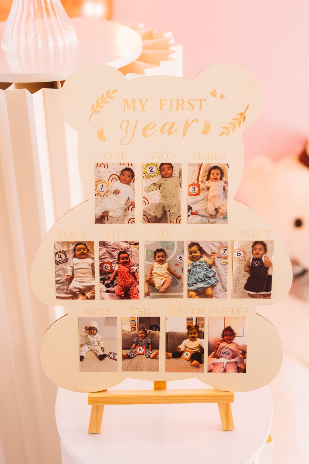 A display board titled "My First Year" with 12 photos of a baby, arranged in order from one to twelve months, each with a number indicating the month.