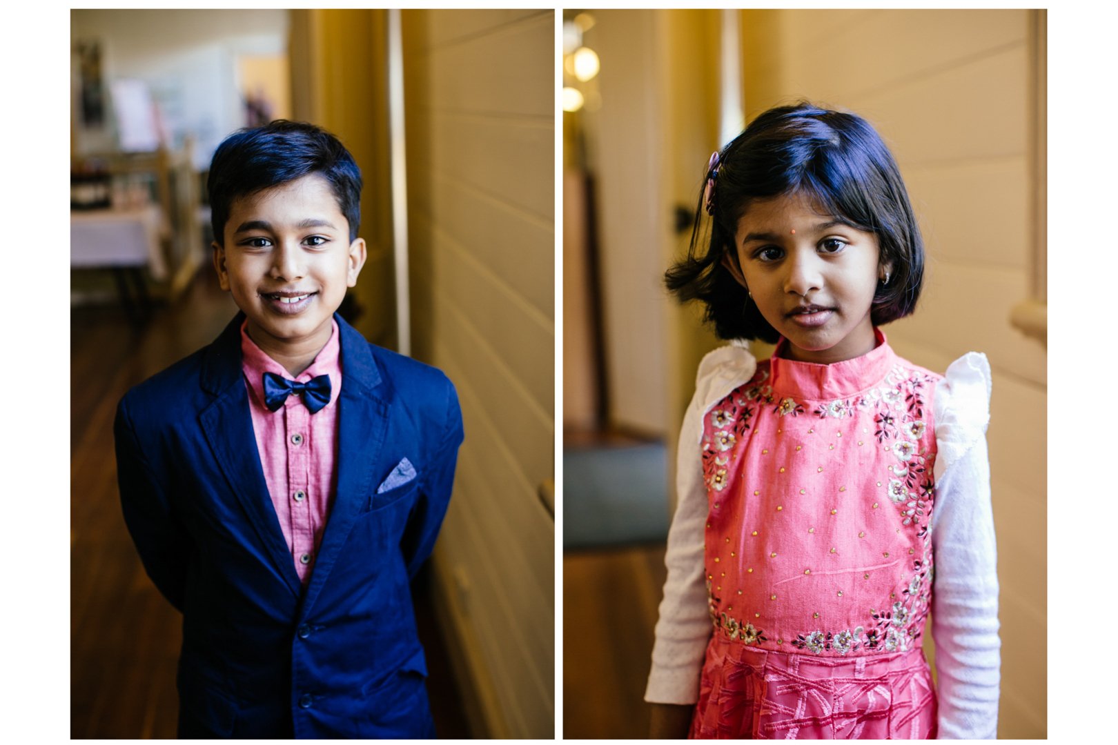 Side-by-side photos of a young boy and girl indoors. The boy is smiling, wearing a navy suit with a pink shirt and bow tie, with short dark hair. The girl has shoulder-length dark hair, wearing a pink embroidered dress with white sleeves, and is look