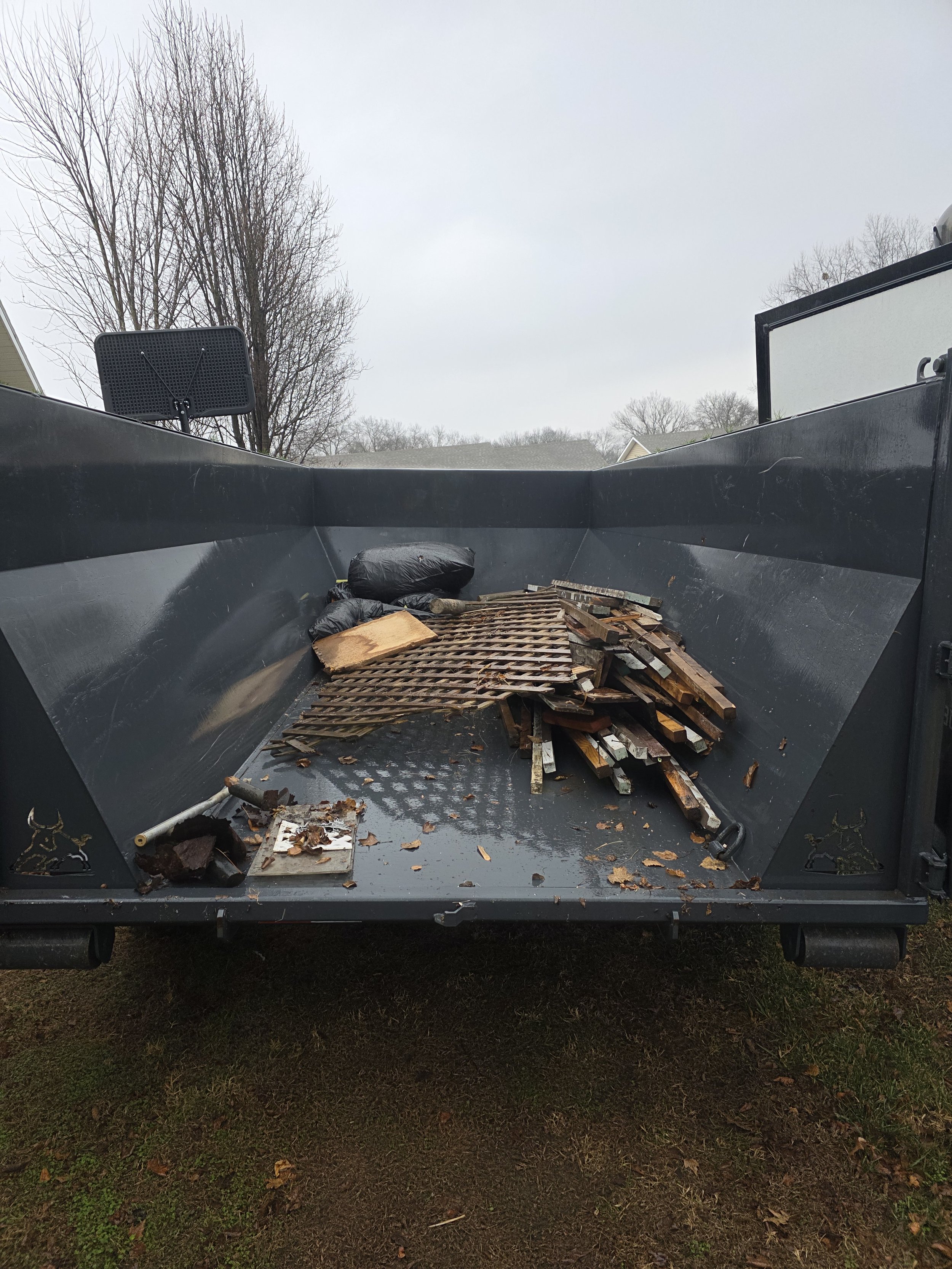 Junk removal in the back of a bin