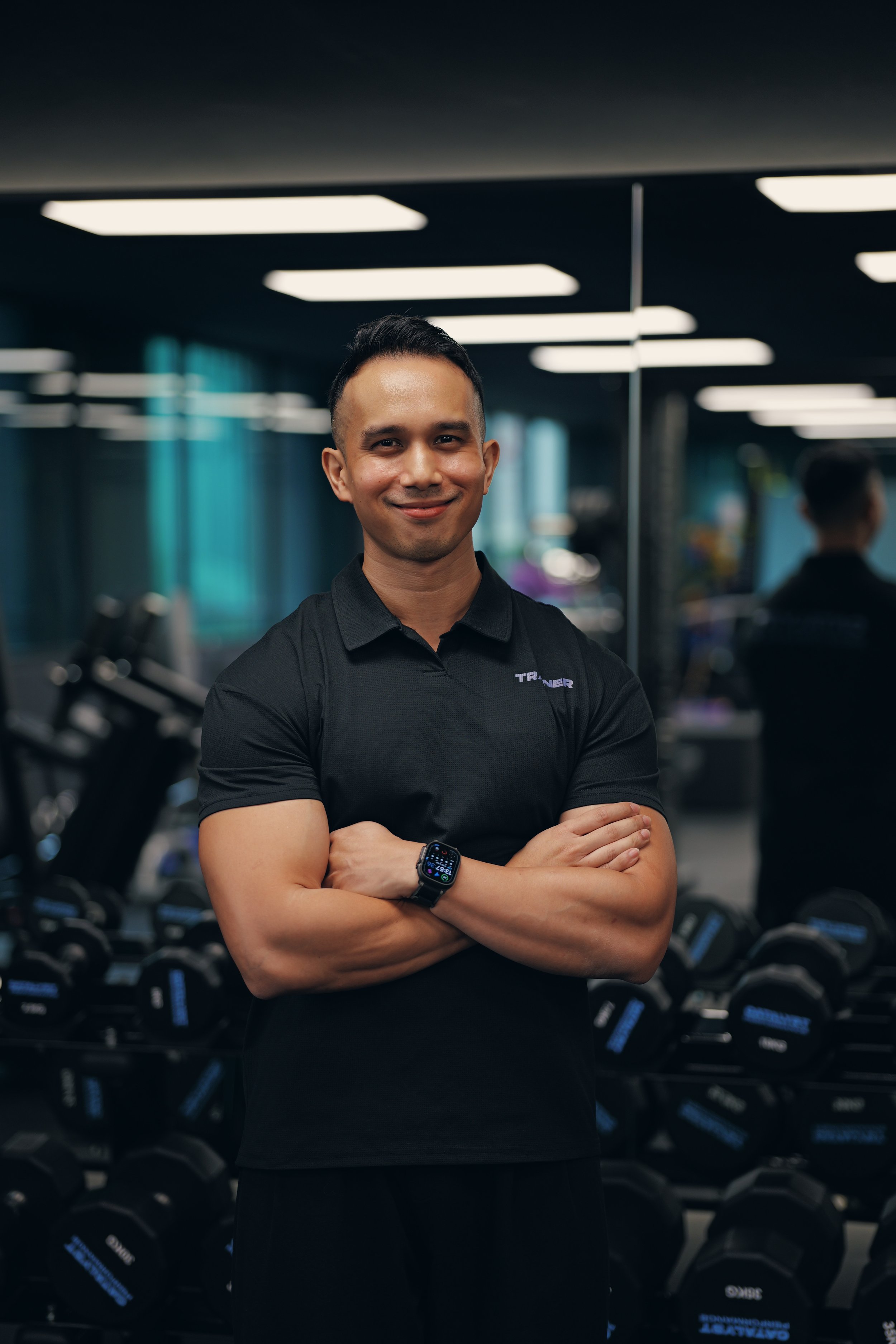 Close-up of a smiling man, in an indoor setting.