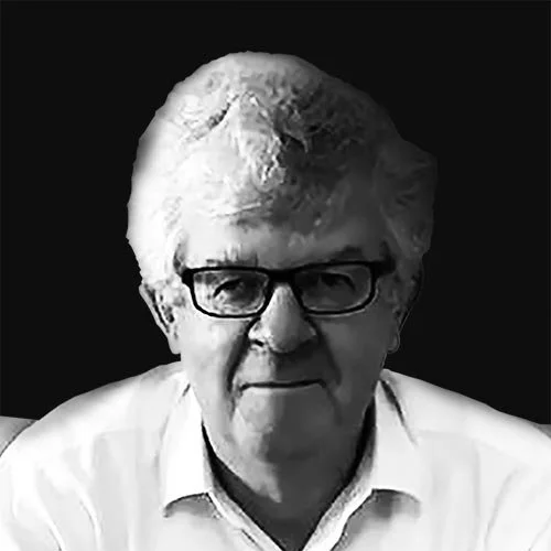 Black and white portrait of an older man wearing glasses and a white collared shirt.