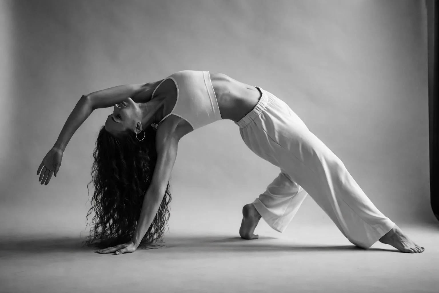 Black and white photograph showing extreme joint flexibility in a woman, illustrating joint hypermobility