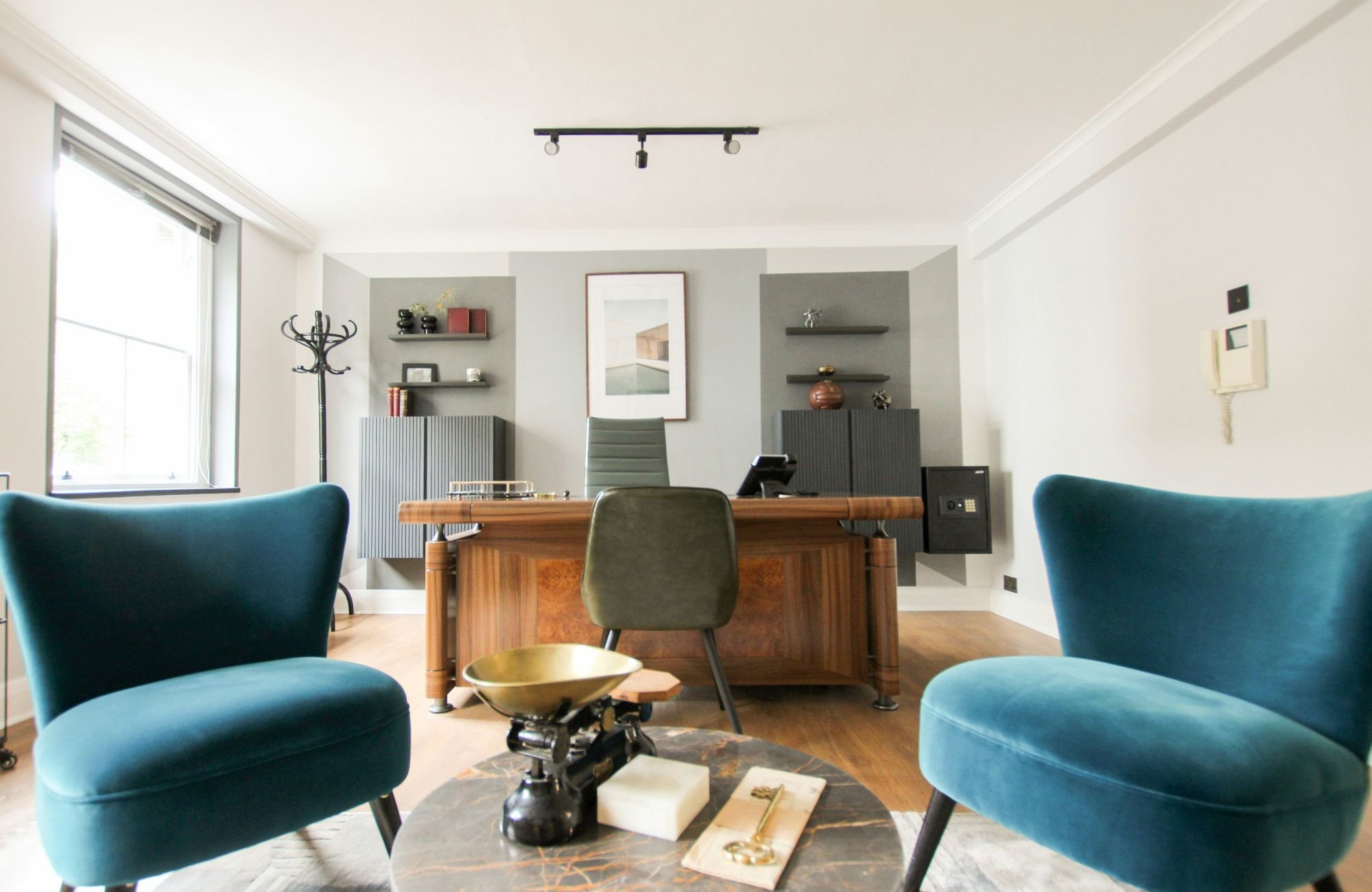 raashi-design-livermore-ca-home-office-design-spacious-office-with-large-desk-sitting-area-blue-upholstered-chairs-high-end-luxury-interior-design.jpg