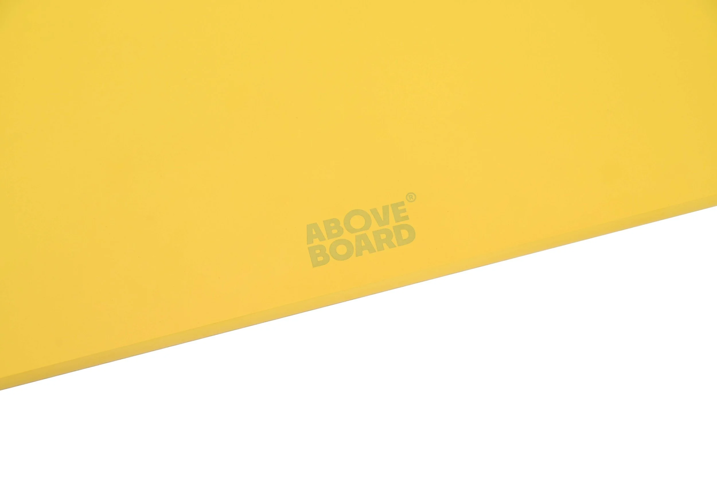 A yellow wood fibre sustainable chopping with the words 'ABOVE BOARD' printed on it.