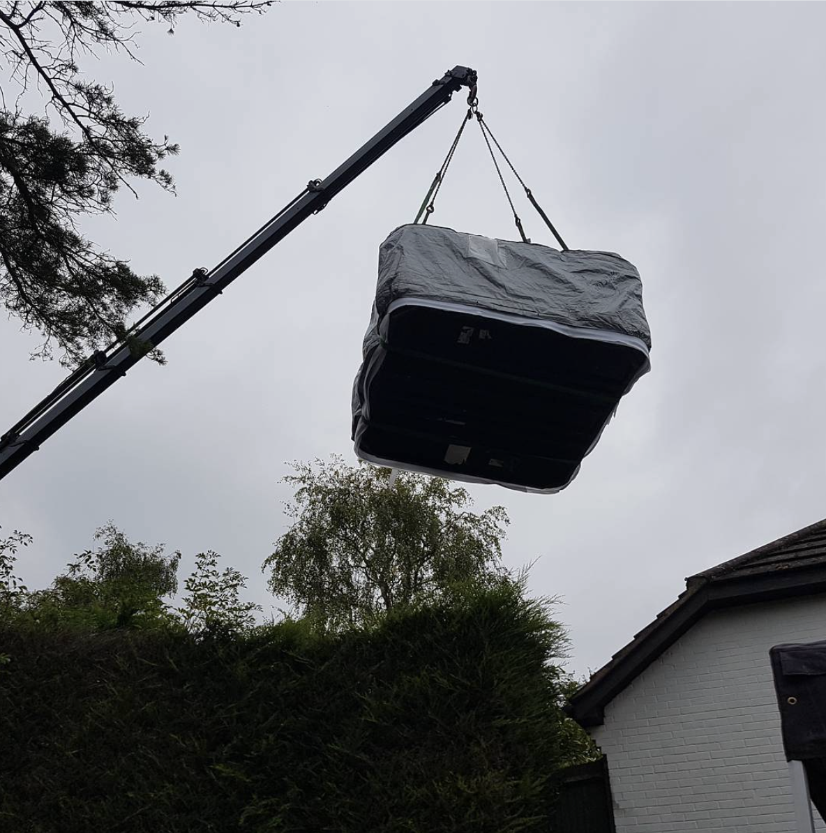 hot tub being craned into garden