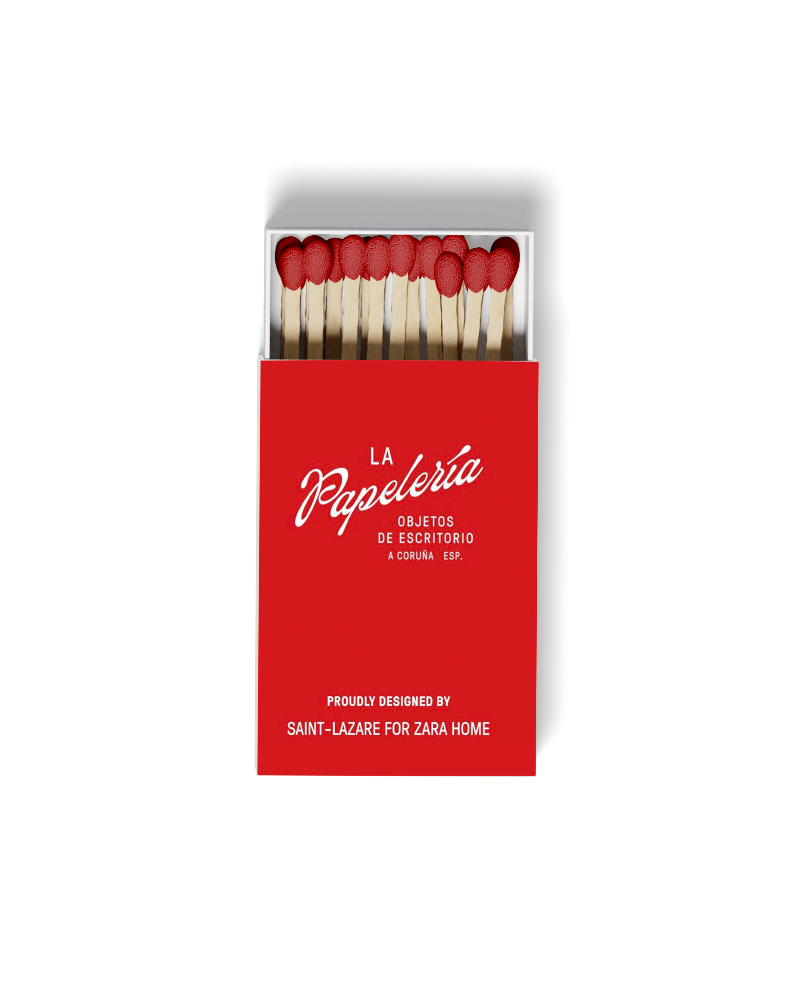 A box of red thumbtacks with wooden sticks, with the box labeled "La Papelera Objetos de Escritorio" and "Proudly designed by Saint-Lazare for Zara Home" on a black background.