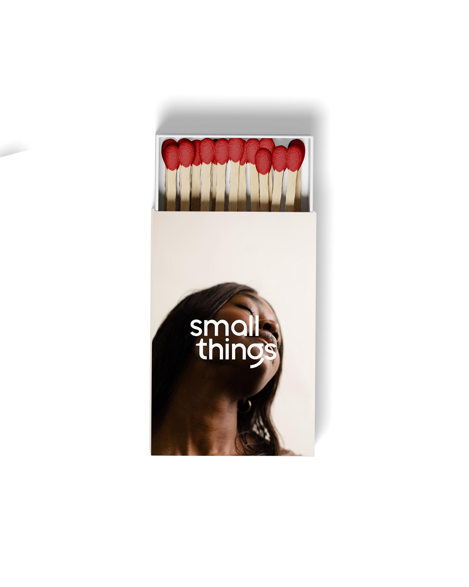 A matchbox labeled 'small things' with an image of a woman and a row of matches with red heads.