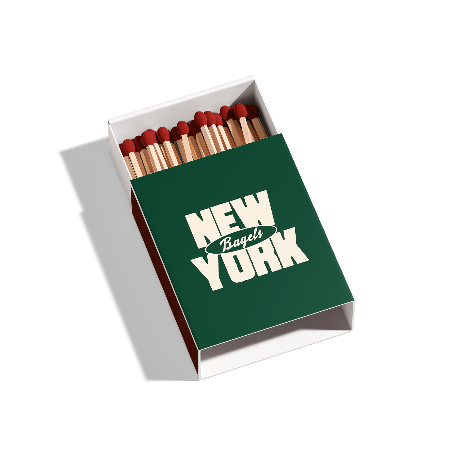 Box of matches with a green cover that reads 'New York Bagels' and contains wooden matches with red heads.