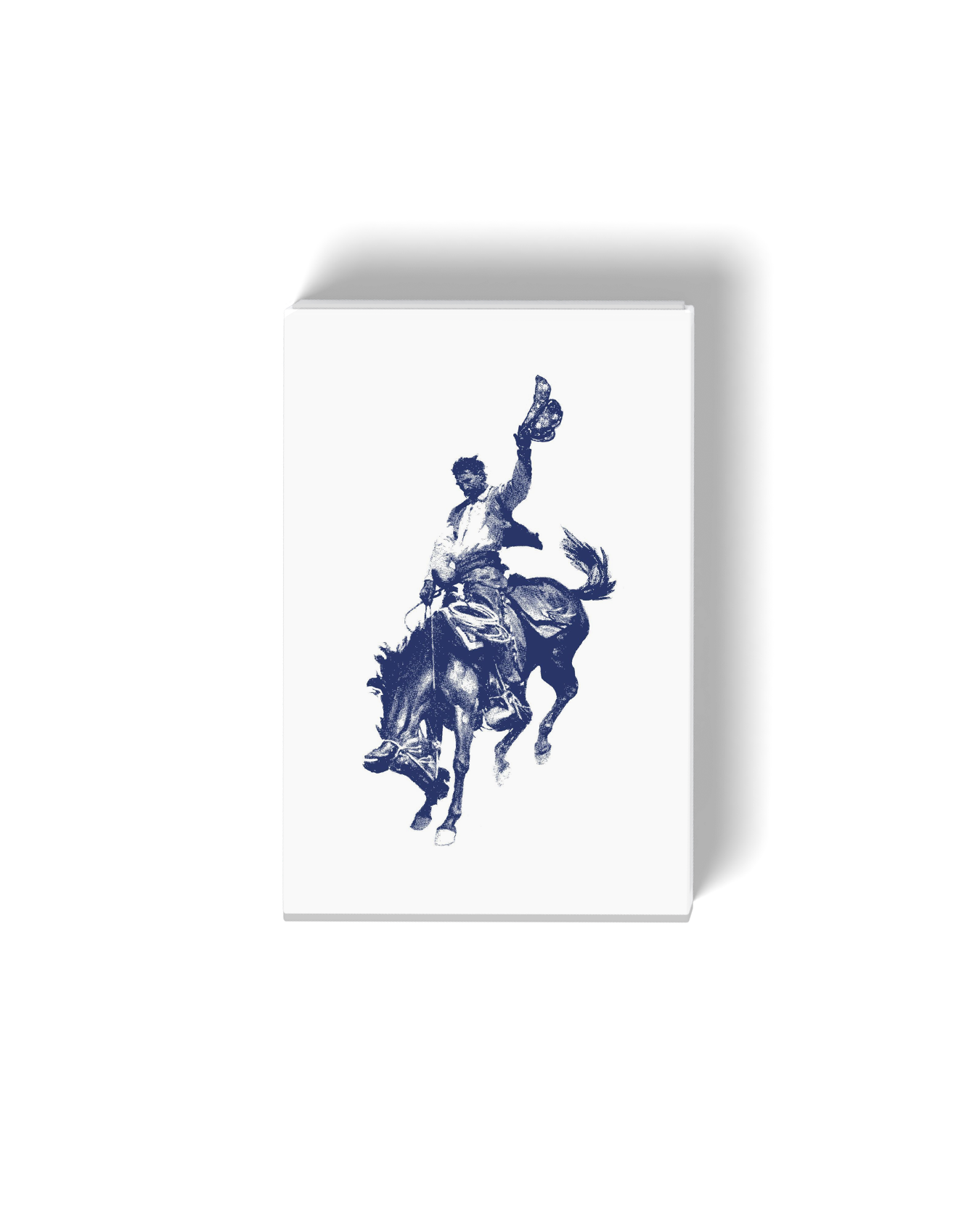 Silhouette of a cowboy riding a bucking horse, holding a hat in one hand.
