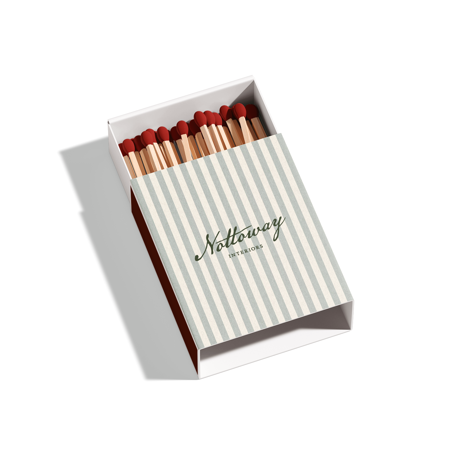 A box of matches with a striped cover that reads 'Notaway Interiors' in cursive and printed fonts.