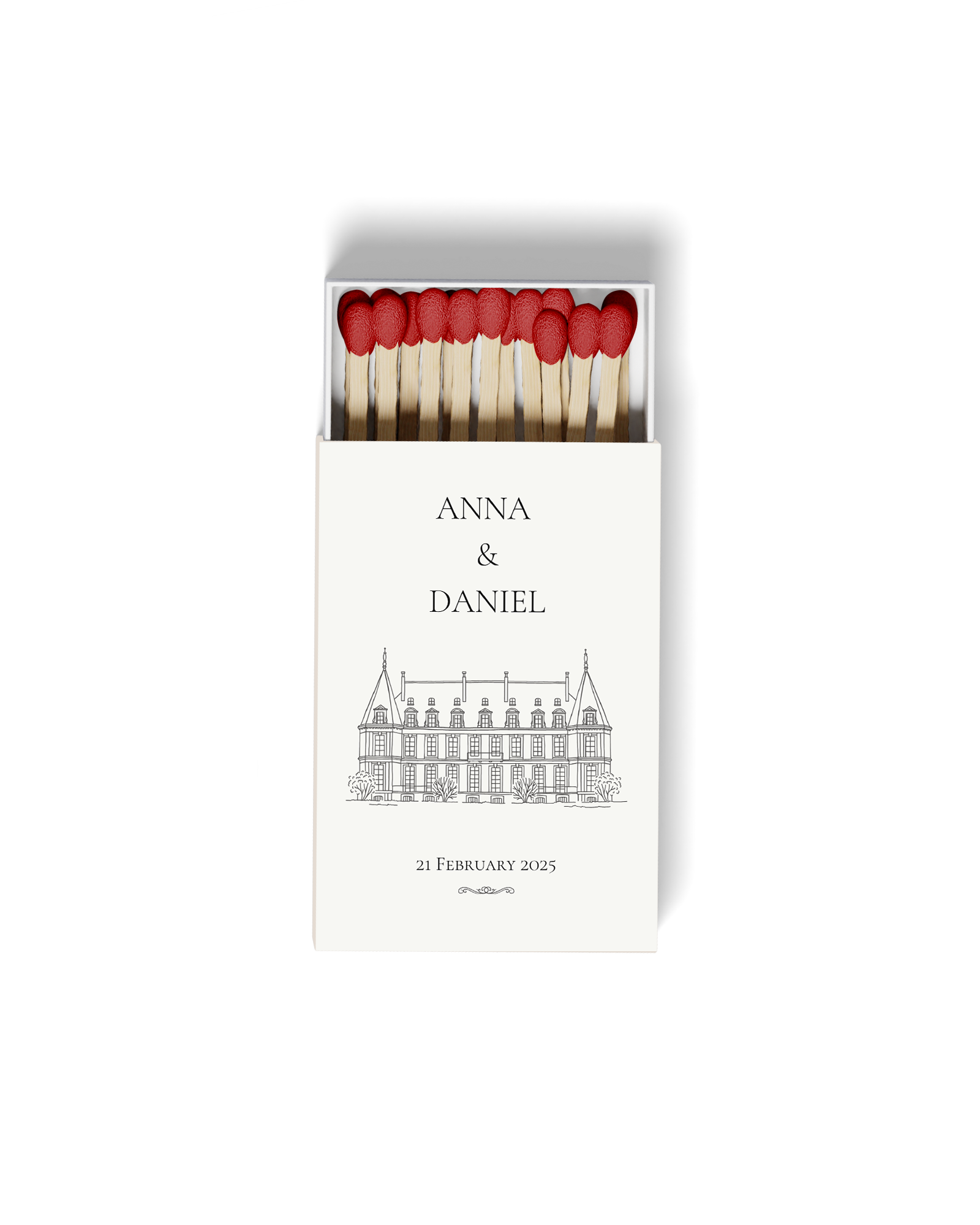 Matchstick box with red-tipped matches and a wedding invitation with names Anna and Daniel, a sketch of a building, and the date 21 February 2025.