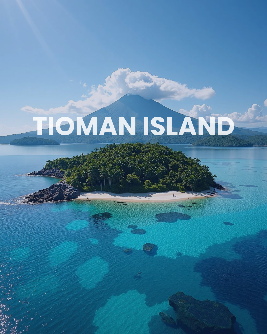 A scenic view of Tioman Island with lush greenery, clear blue waters, and a mountainous backdrop, featuring a cloud-covered mountain and a small sandy beach.