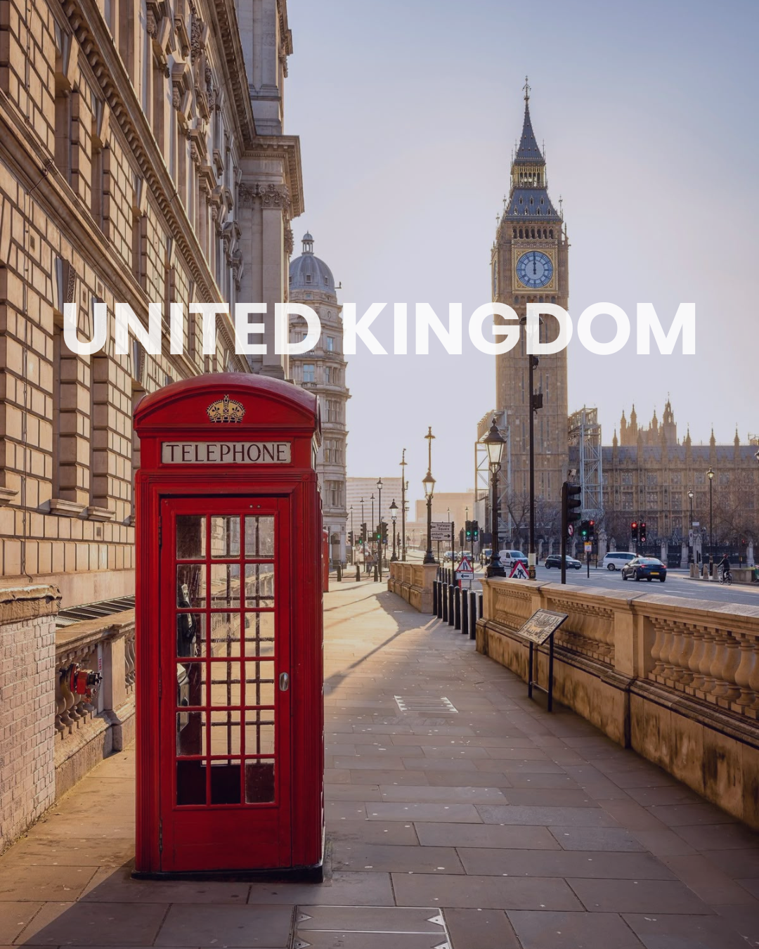 Red British telephone booth on a city sidewalk with Big Ben and the Houses of Parliament in the background in London, United Kingdom.