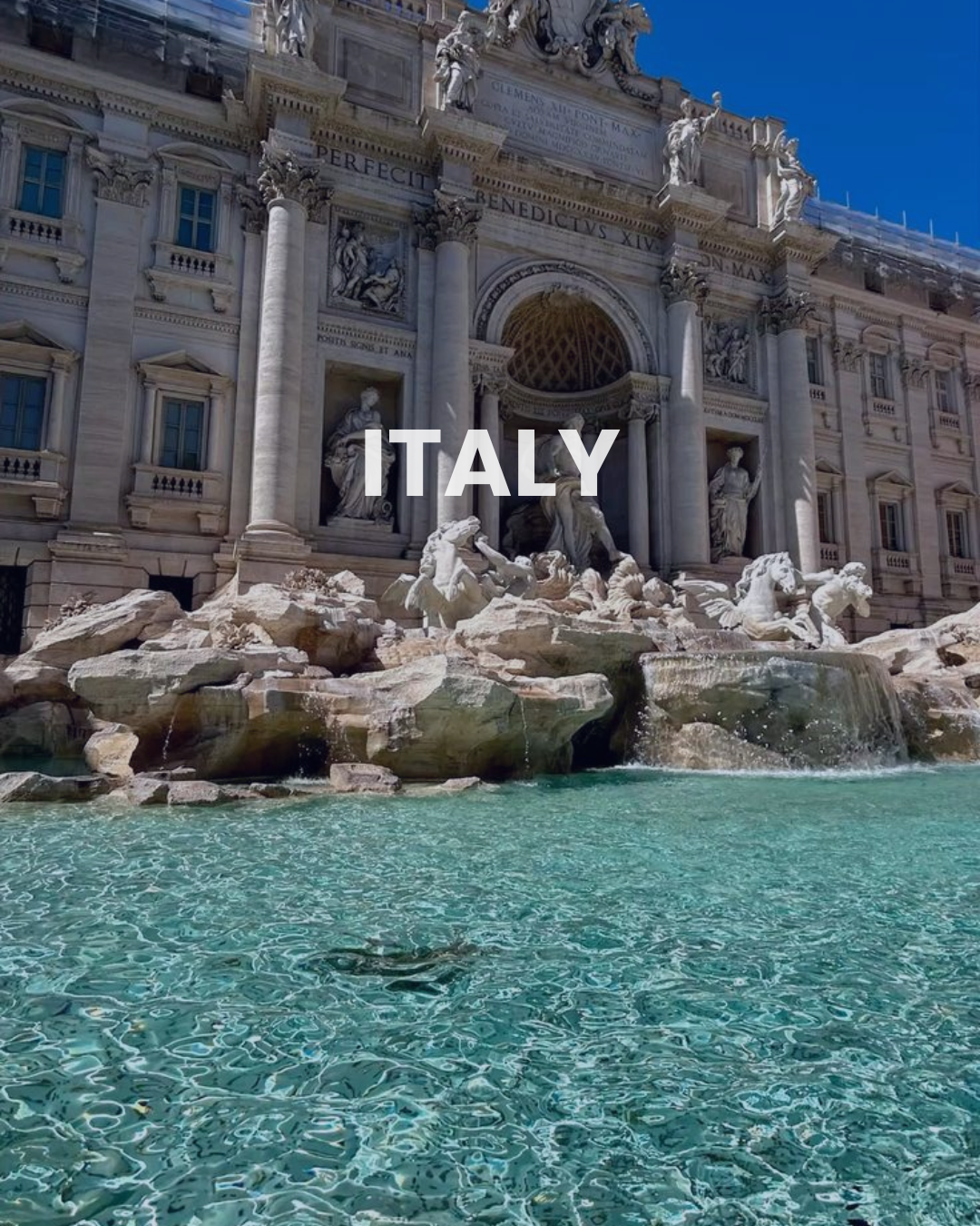 The Trevi Fountain in Rome, Italy, featuring elaborate sculptures and cascading water in a historic architectural setting under a clear blue sky.