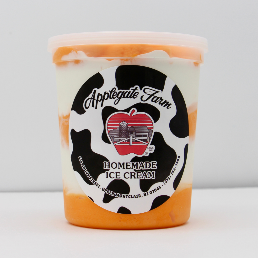 Container of Applegate Farm homemade ice cream with a black and white cow print label, featuring a red apple with a barn and silo illustration.