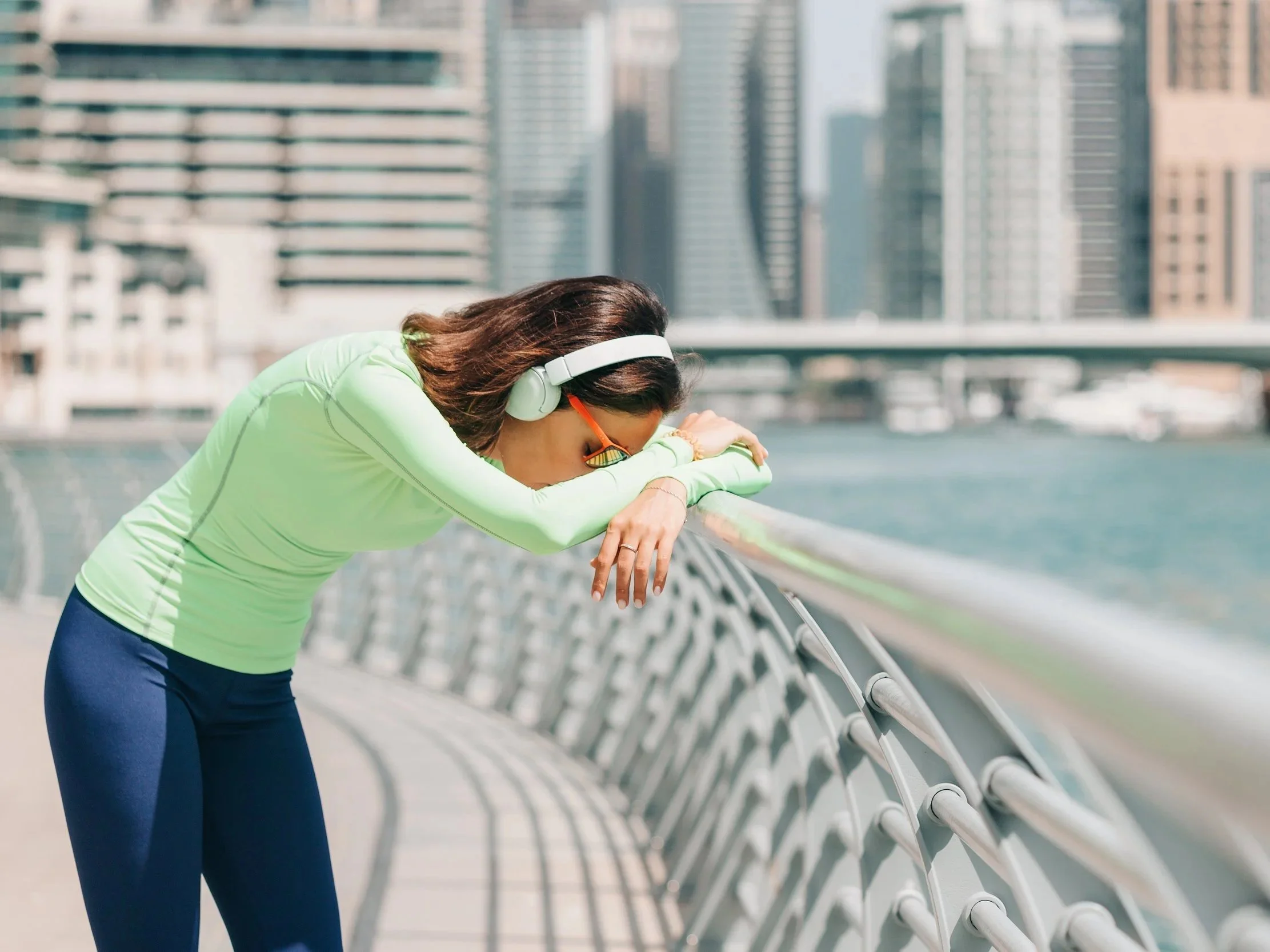 Woman exercising leaning over railing because she is short of breath with bronchiectasis