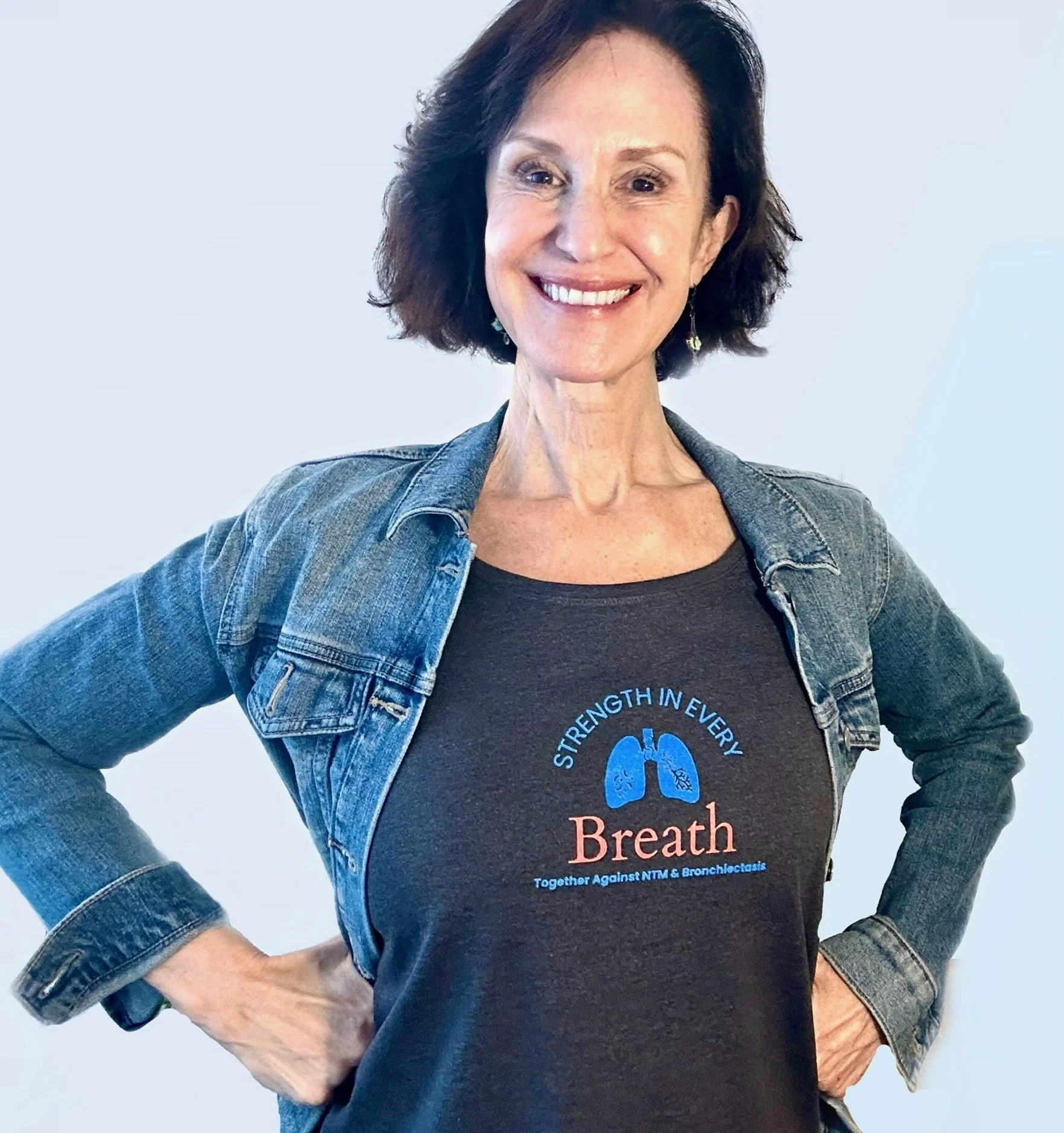 Linda Esposito, bronchiectasis health navigator and coach with her hands on her hips smiling